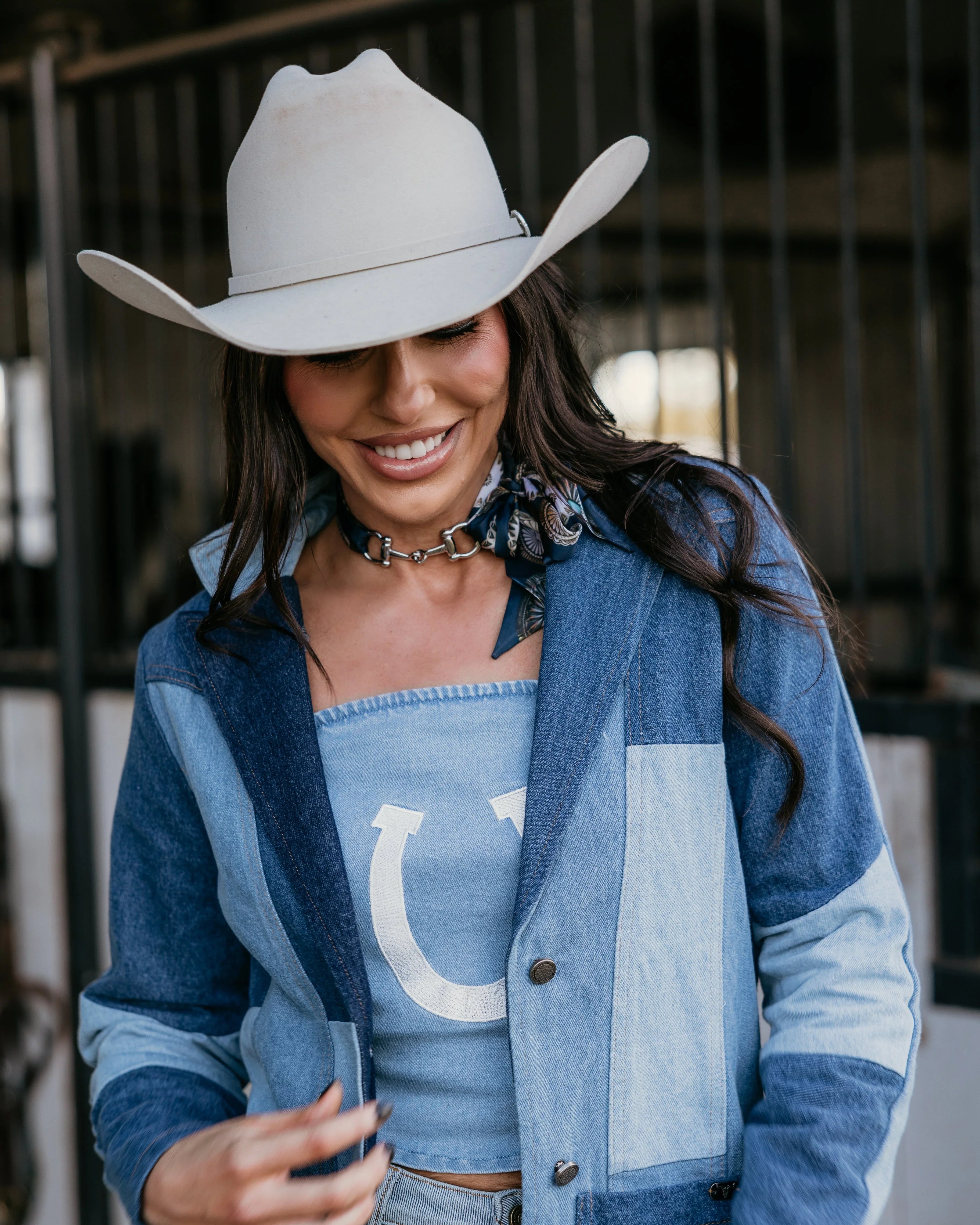 Woman in western boho denim jacket and cowboy hat, rodeo outfit inspiration