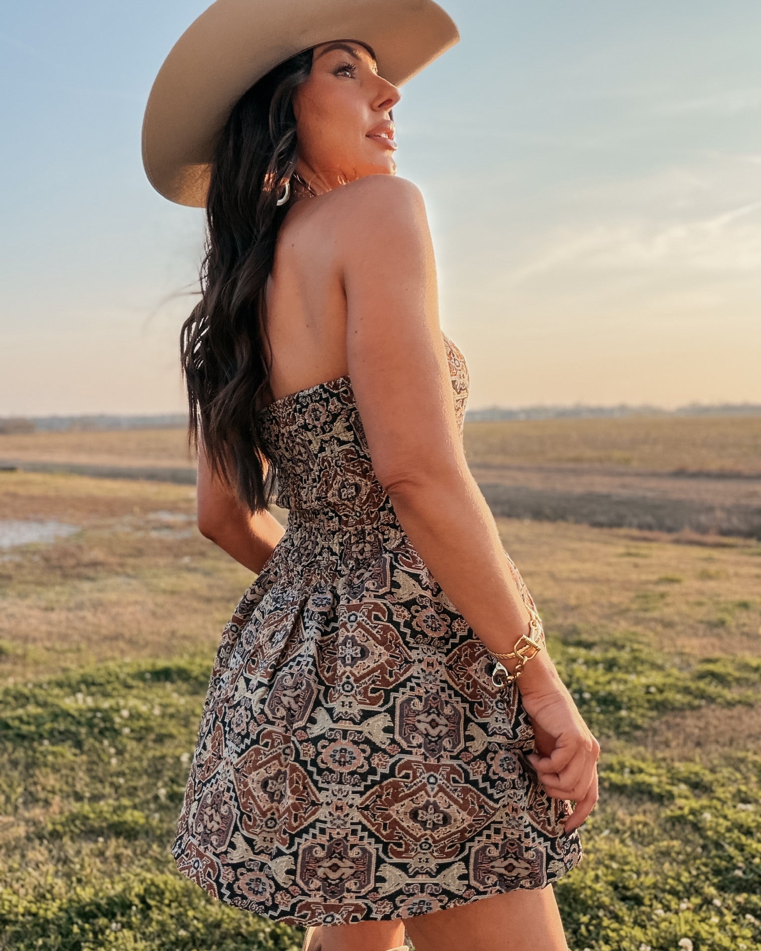 Thunderbird pendant chain necklace displayed on wooden slab with serape fabric underneath - The Wild J