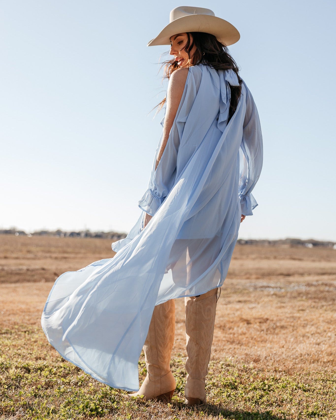 Thunderbird pendant chain necklace displayed on wooden slab with serape fabric underneath - The Wild J
