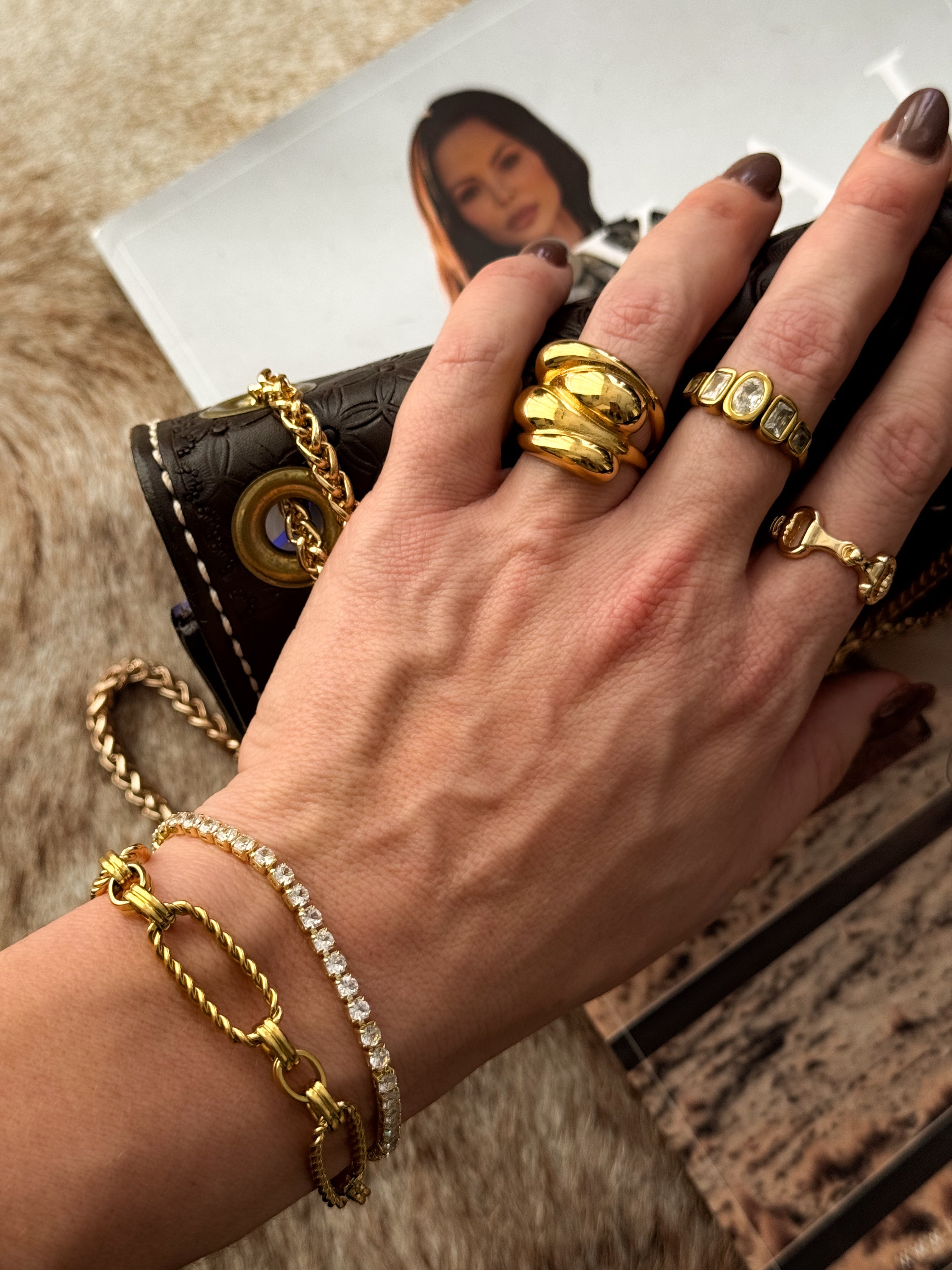 Thunderbird pendant chain necklace displayed on wooden slab with serape fabric underneath - The Wild J