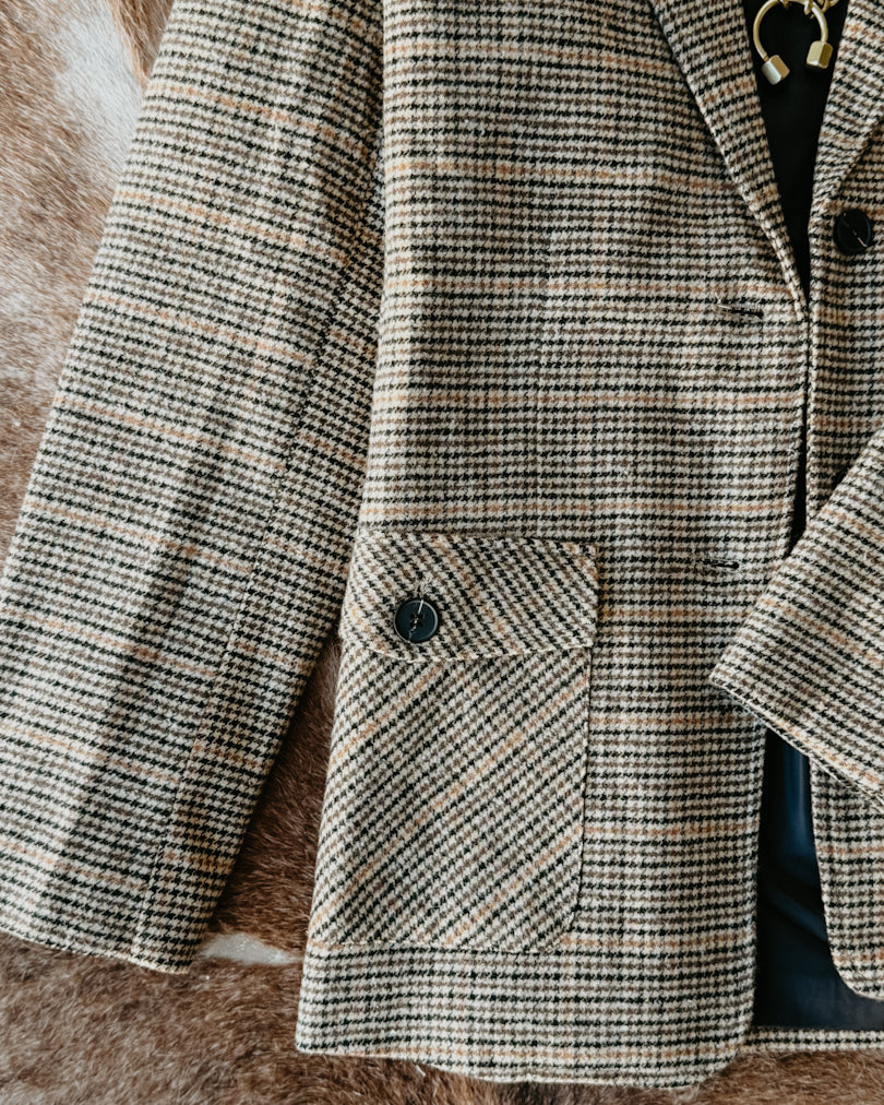 Houndstooth patterned coat on a textured surface