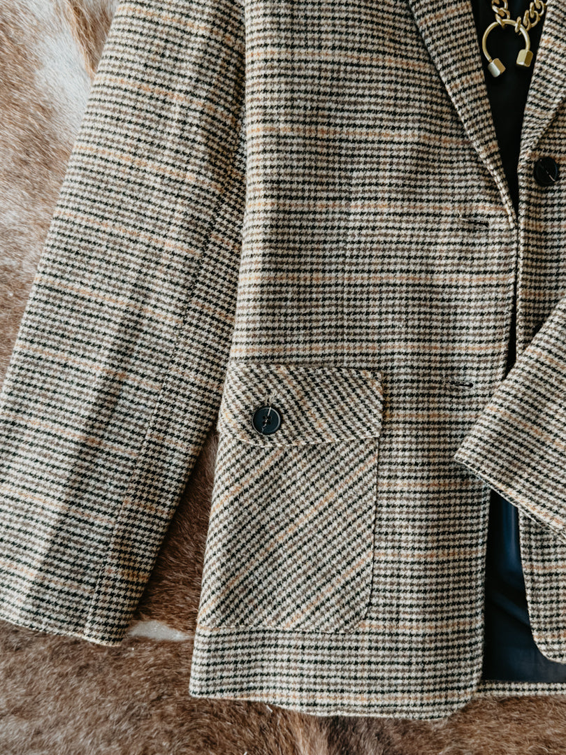 Houndstooth patterned coat on a textured surface