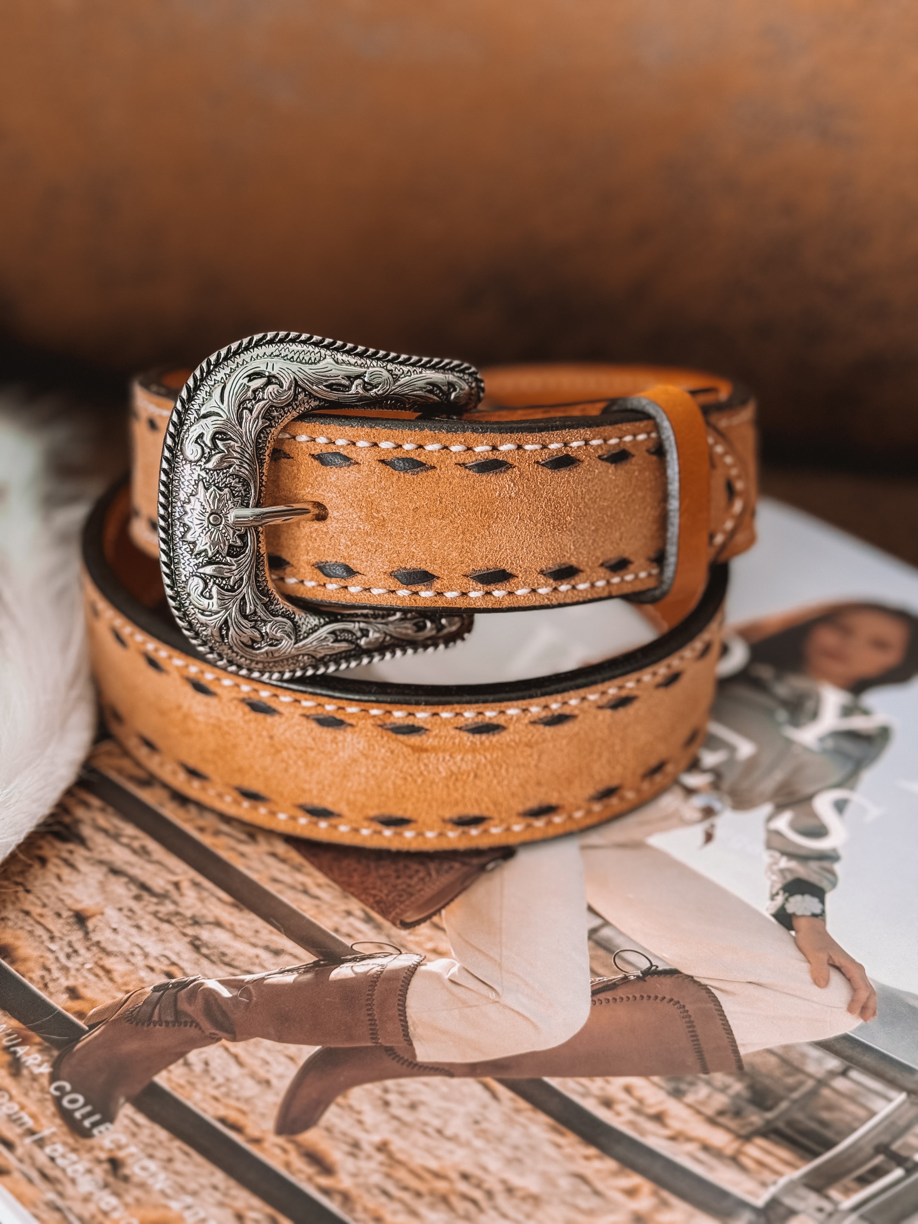 Tan western leather belt with engraved silver buckle, styled with cowgirl fashion magazine