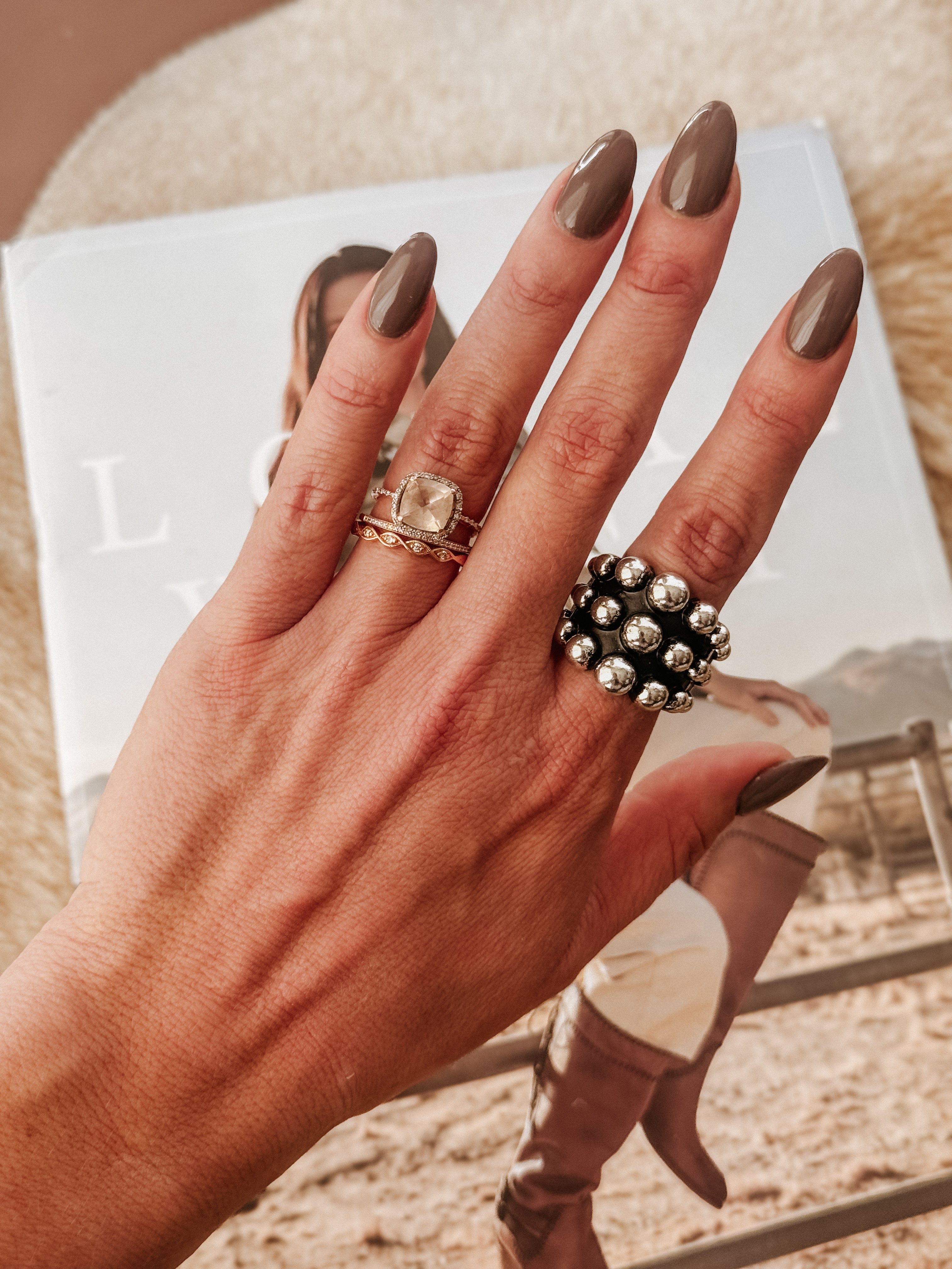 Thunderbird pendant chain necklace displayed on wooden slab with serape fabric underneath - The Wild J