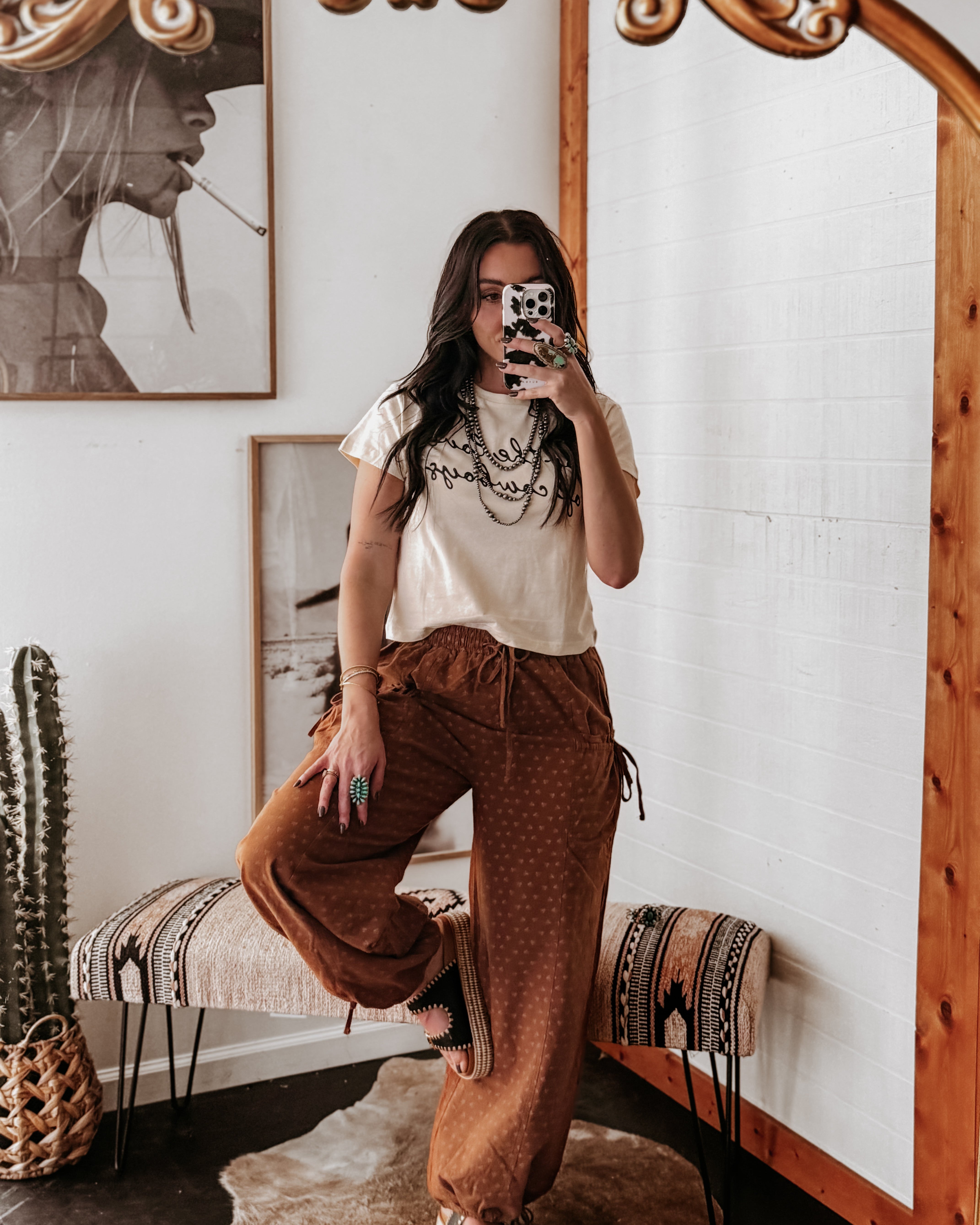Thunderbird pendant chain necklace displayed on wooden slab with serape fabric underneath - The Wild J