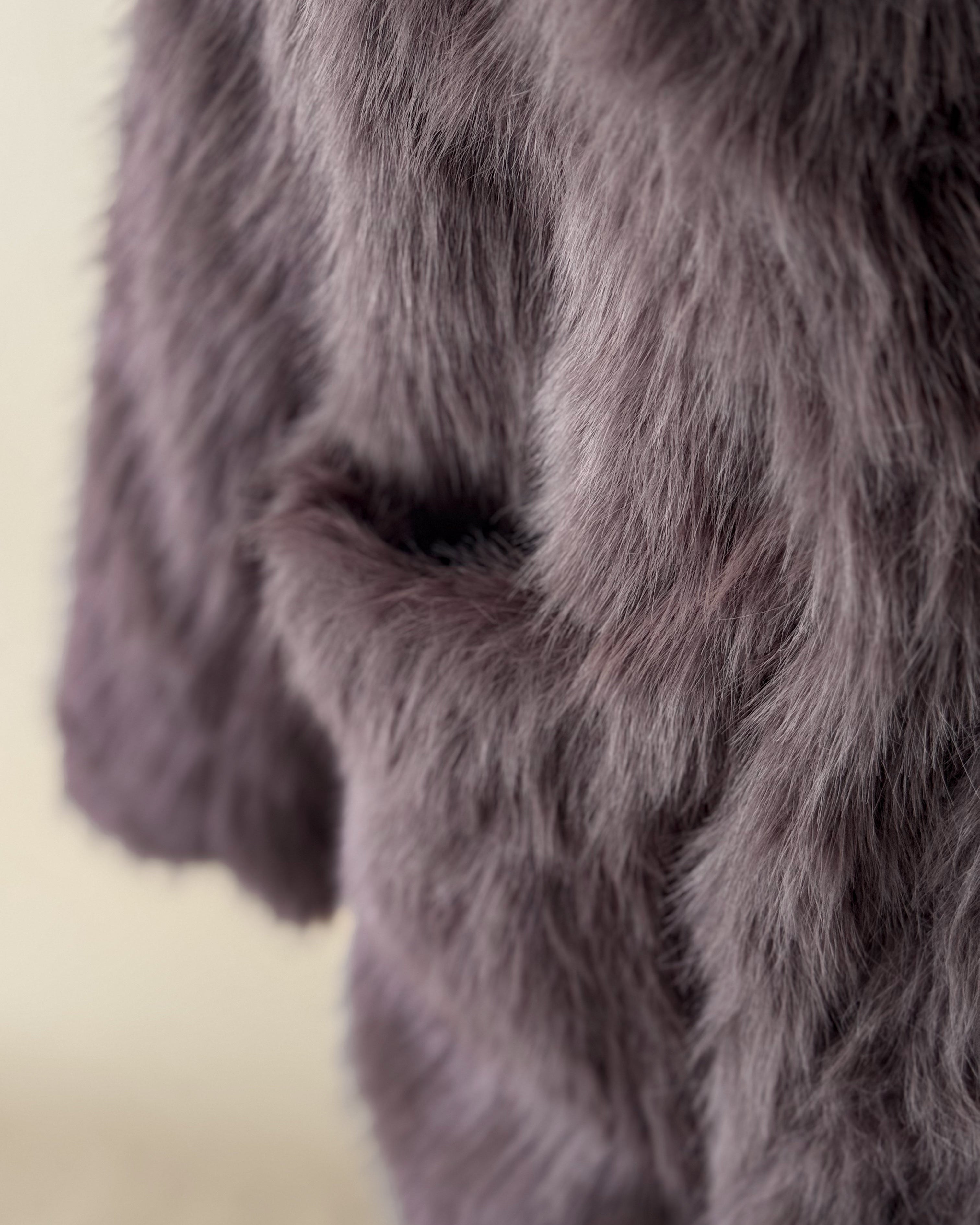 Close-up of soft faux fur in a mauve color, perfect for western boho outfits or jackets.
