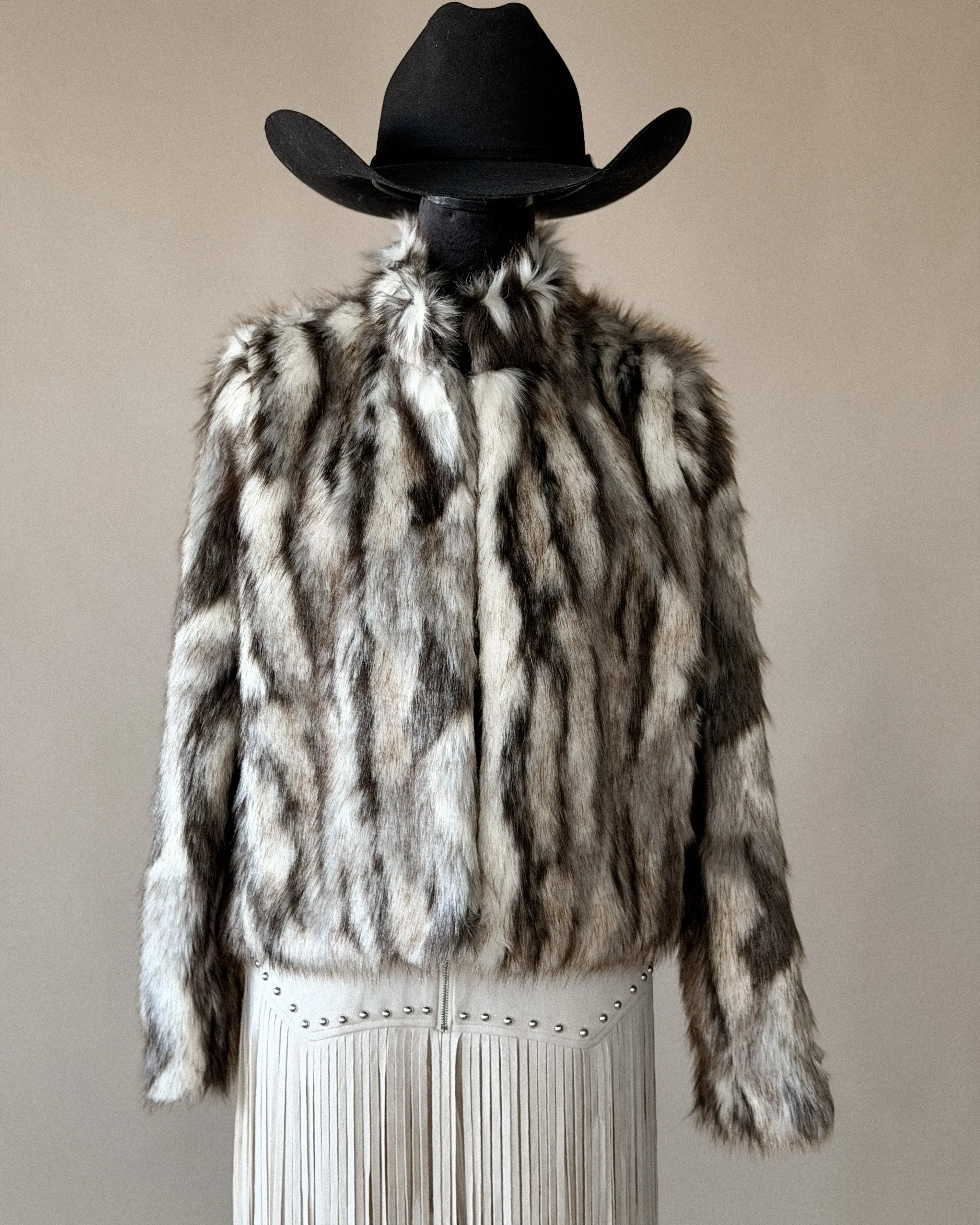 Western faux fur jacket with fringe skirt and black cowboy hat, boho rodeo outfit