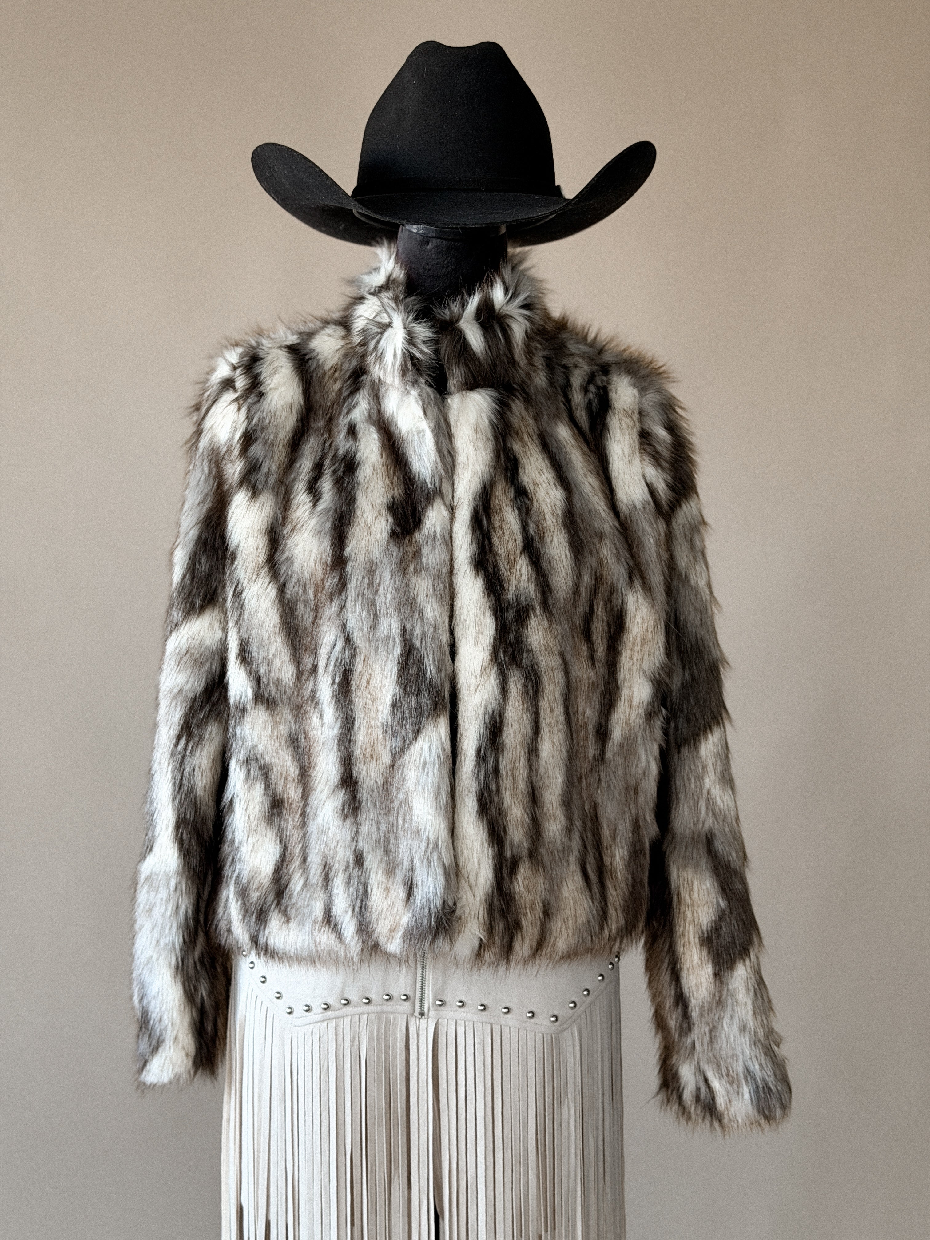 Western faux fur jacket with fringe skirt and black cowboy hat, boho rodeo outfit