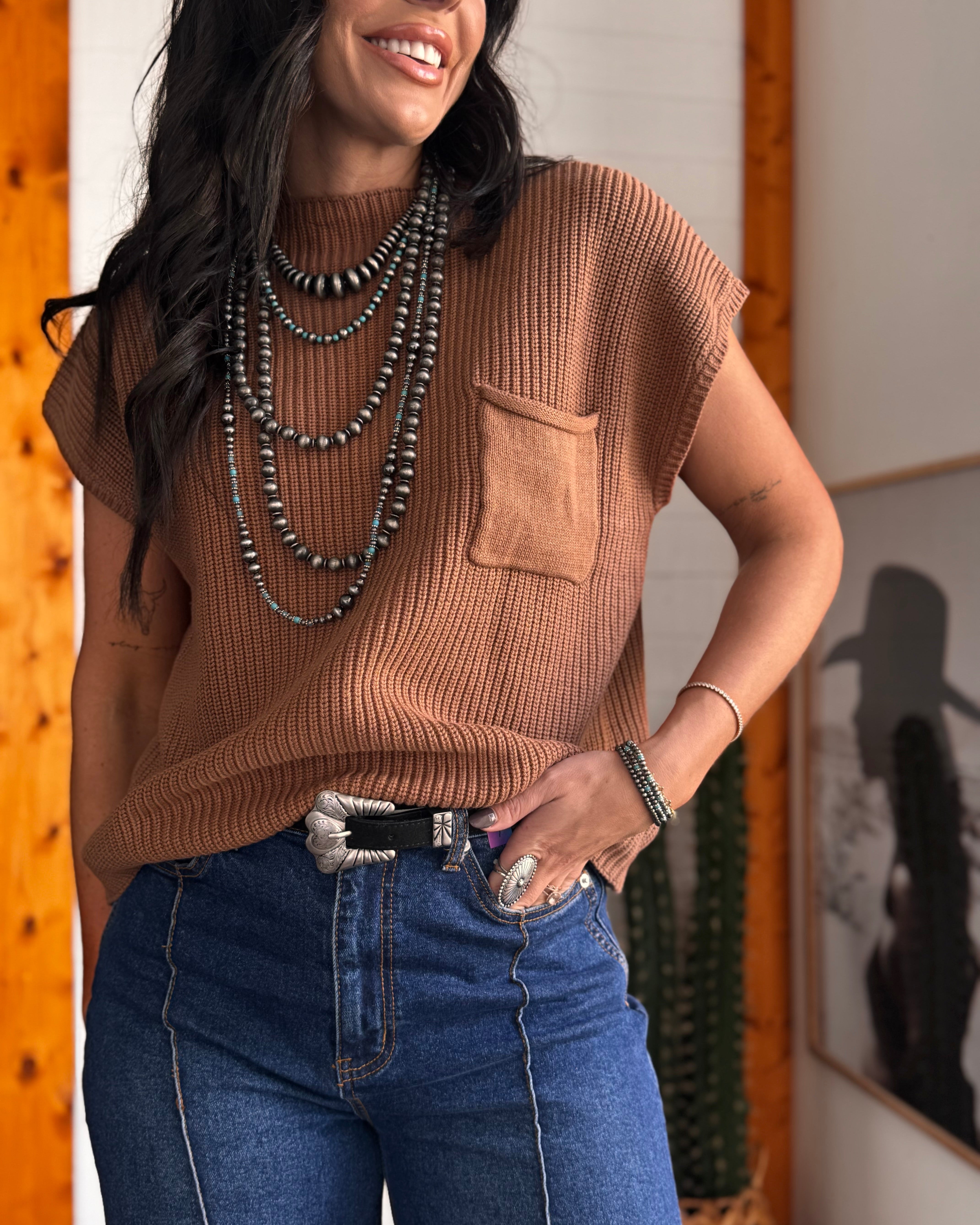 Thunderbird pendant chain necklace displayed on wooden slab with serape fabric underneath - The Wild J