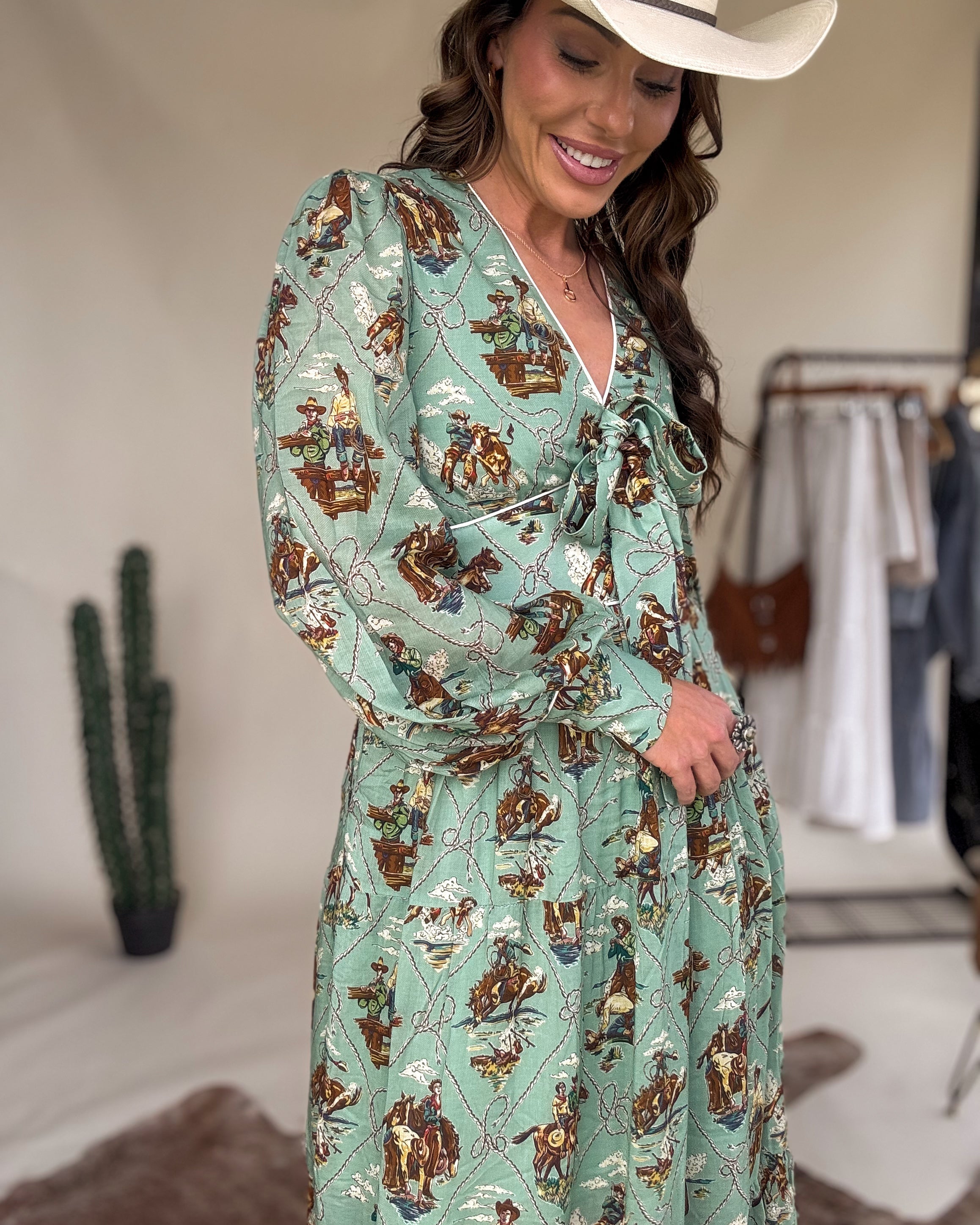 Woman in green western print dress and cowboy hat, western boho outfit, boutique style