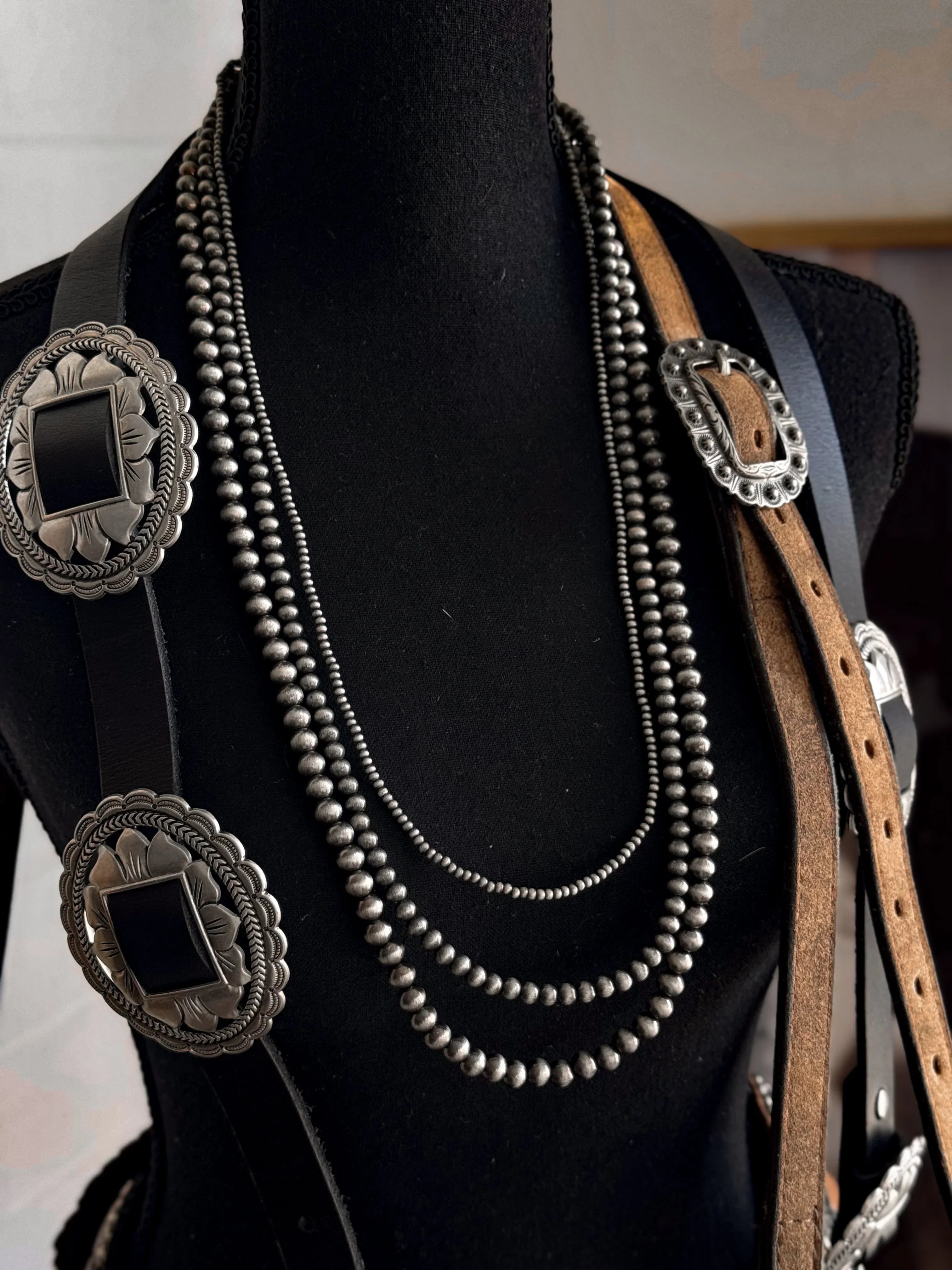 Necklace with concho details on a black mannequin