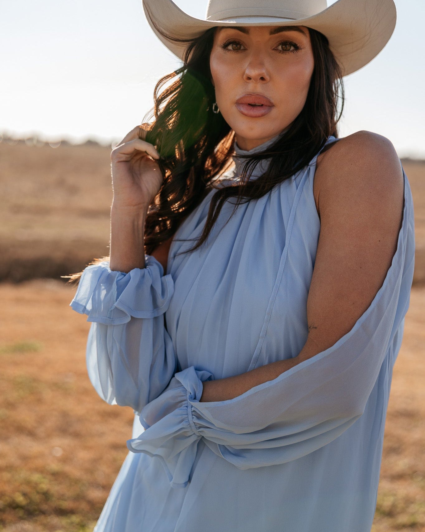 Thunderbird pendant chain necklace displayed on wooden slab with serape fabric underneath - The Wild J