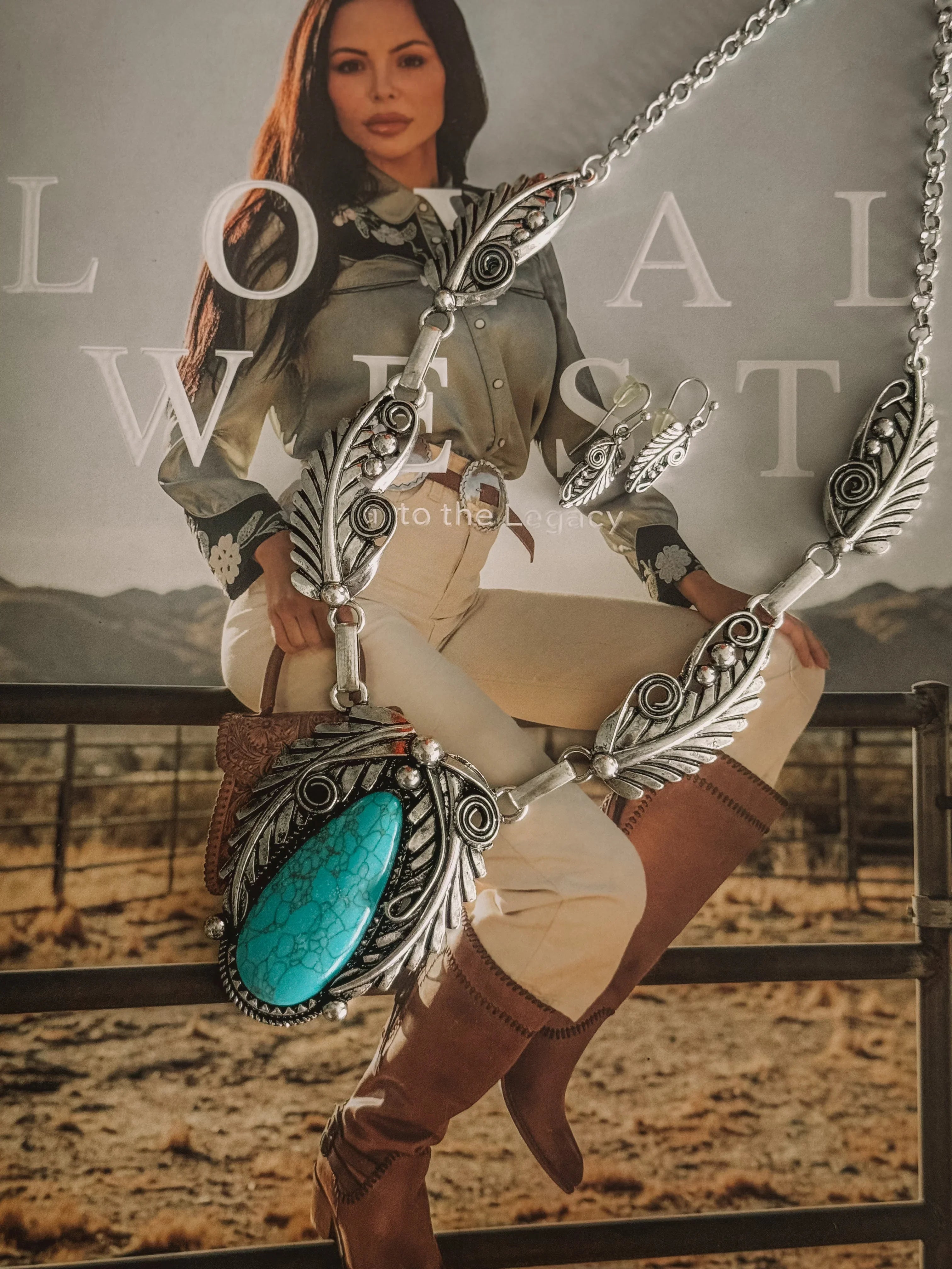Western boho turquoise necklace and earrings with feather details, styled on cowgirl fashion magazine.