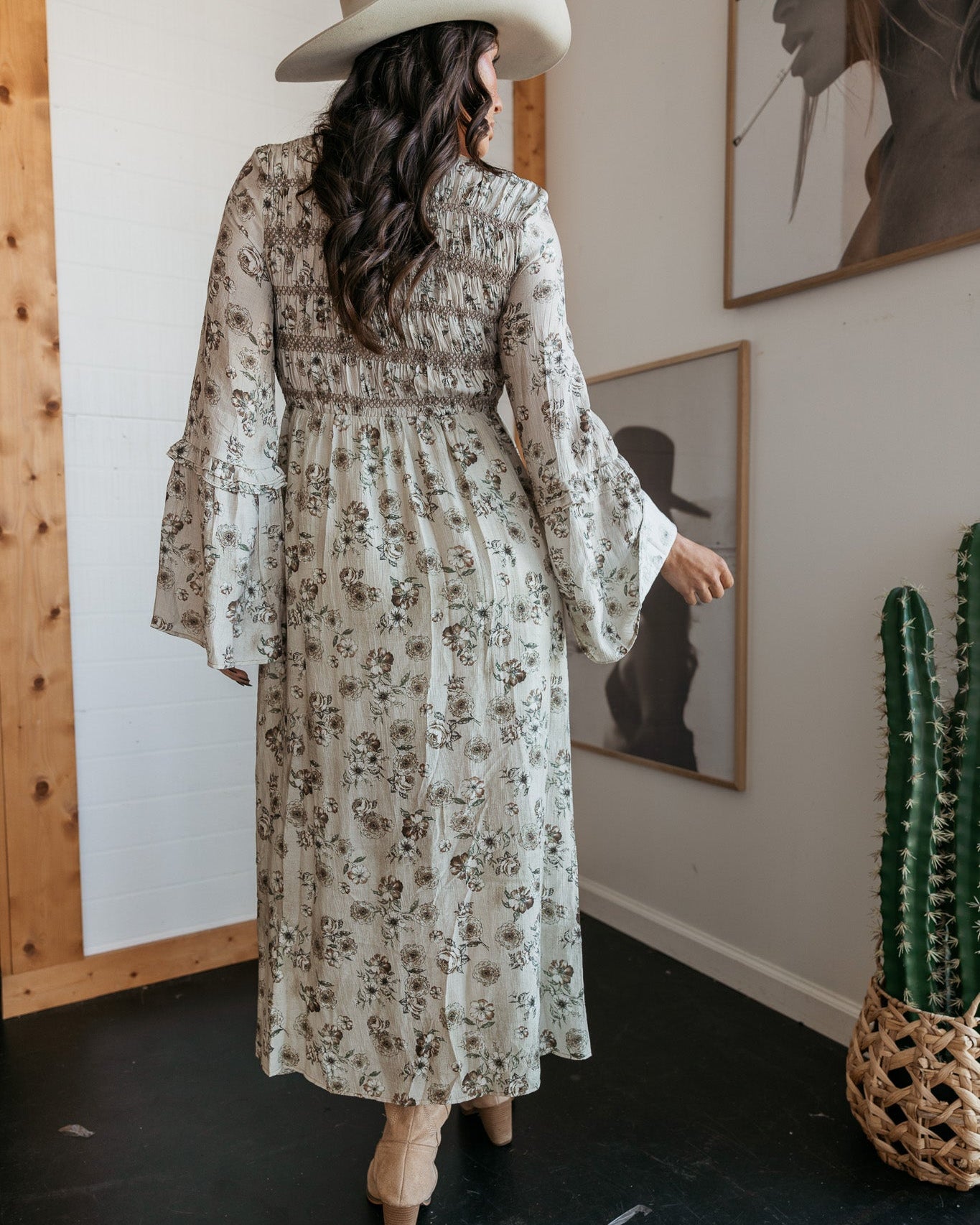 Woman in floral western maxi dress and cowboy hat, boho outfit with long sleeves