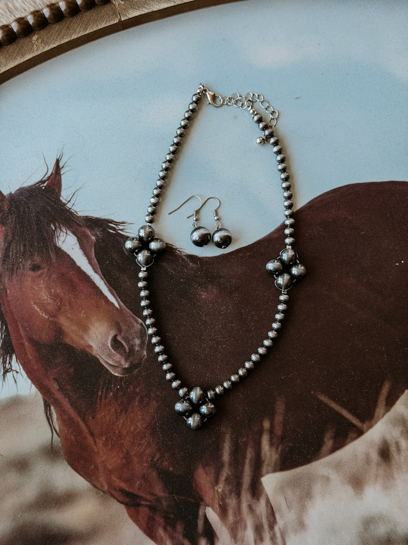 Western silver beaded necklace and dangle earrings set on a horse background, boho jewelry