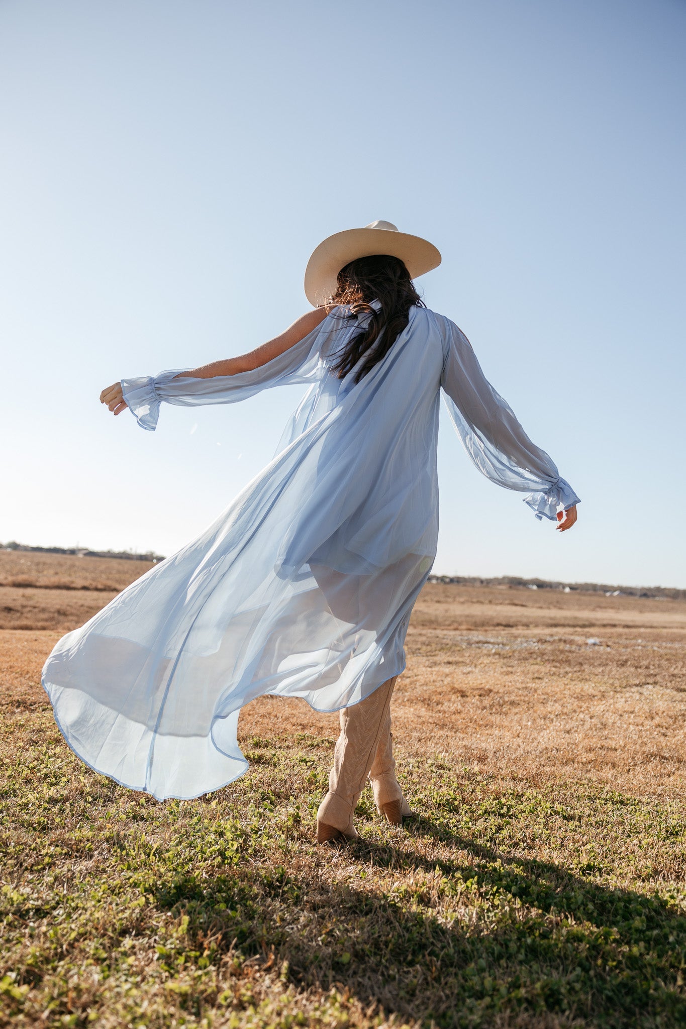 Thunderbird pendant chain necklace displayed on wooden slab with serape fabric underneath - The Wild J