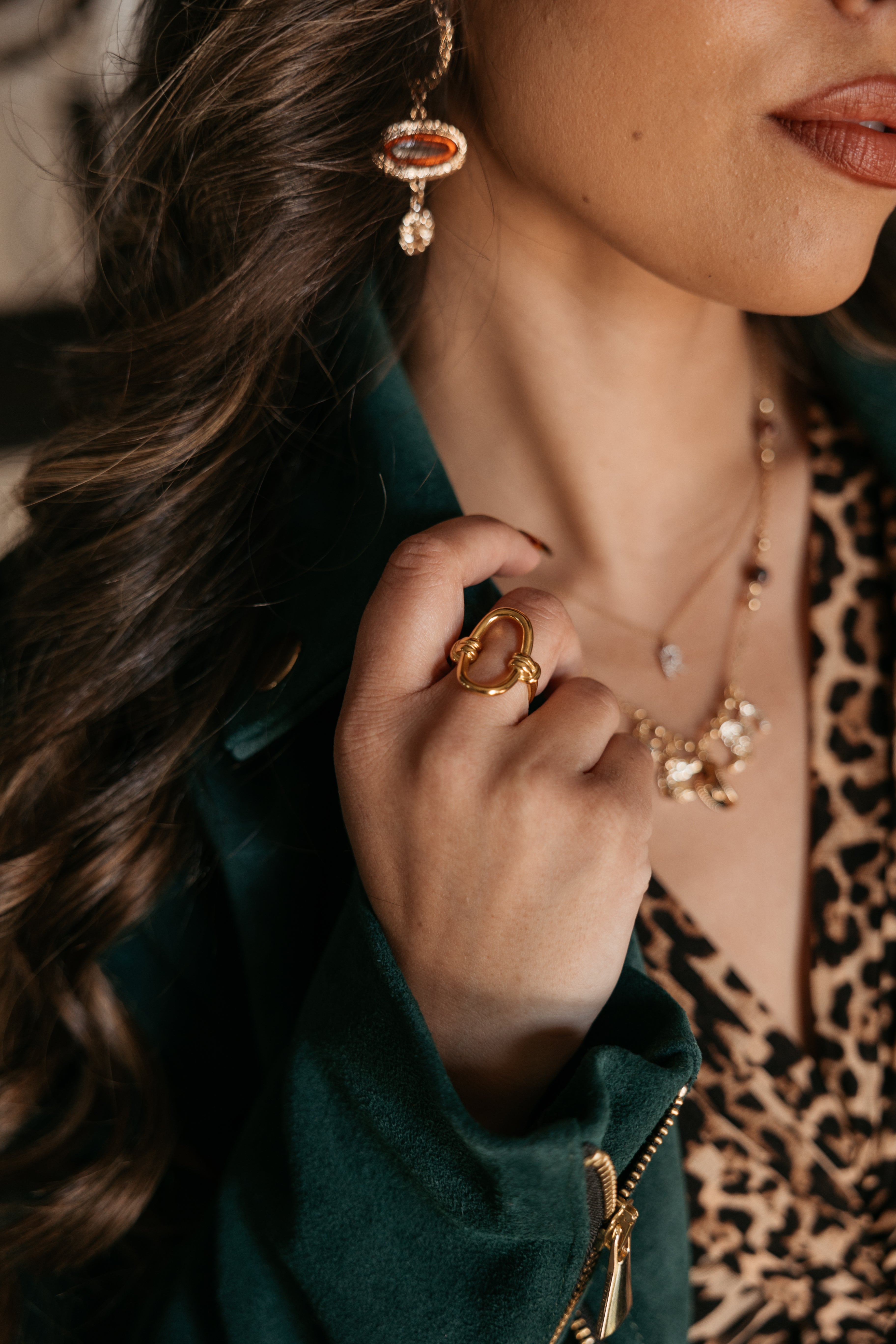 Thunderbird pendant chain necklace displayed on wooden slab with serape fabric underneath - The Wild J