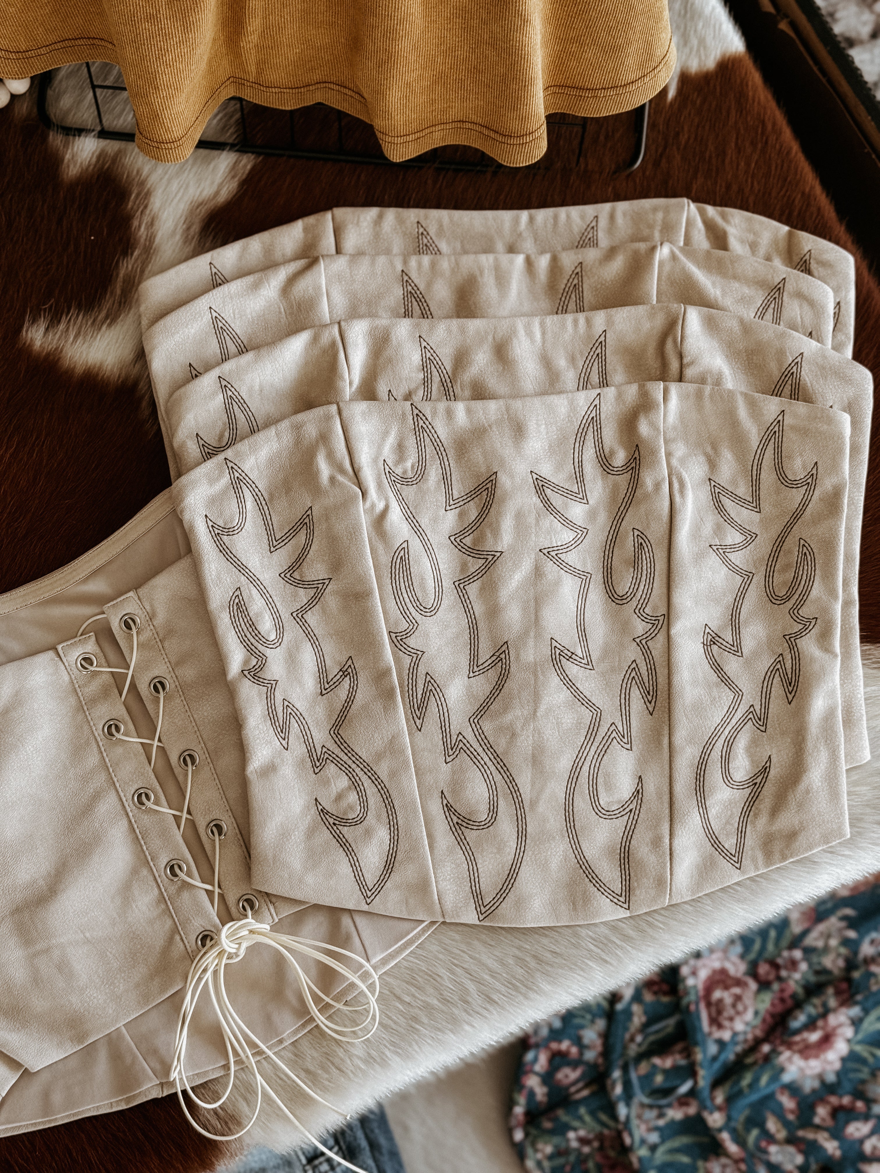 Beige western embroidered corset tops with lace-up detail on cowhide, boho festival outfits