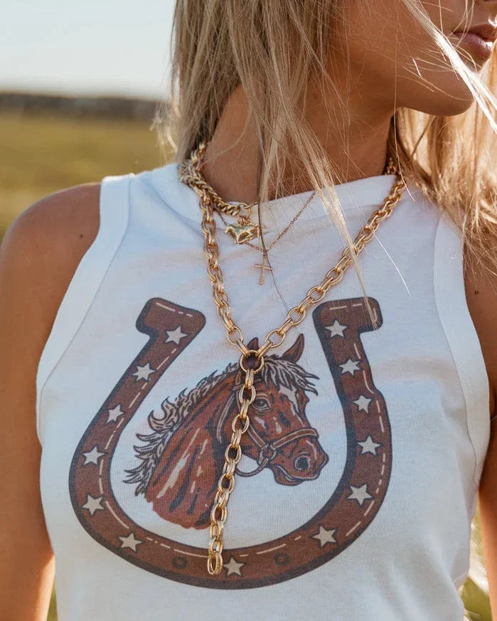 Layered gold chain necklace styled with western graphic tank