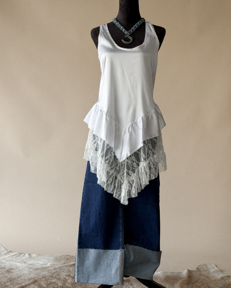 Western boho outfit with white lace tank top, layered necklace, and patchwork denim skirt
