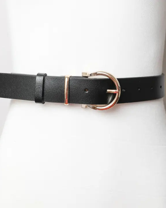 Black western leather belt with gold buckle on mannequin, cowgirl fashion accessory