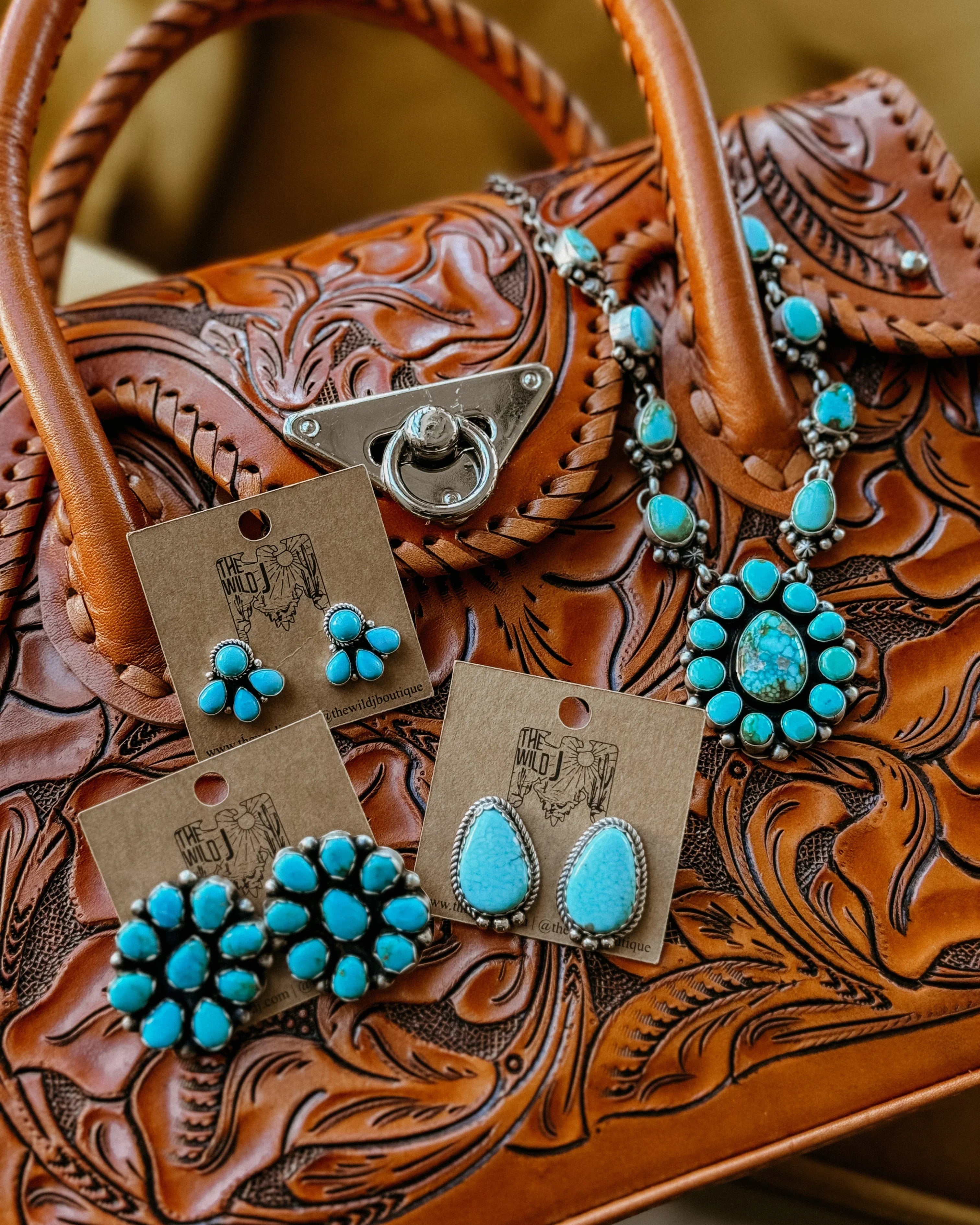 Tooled leather western handbag with turquoise boho earrings and statement necklace