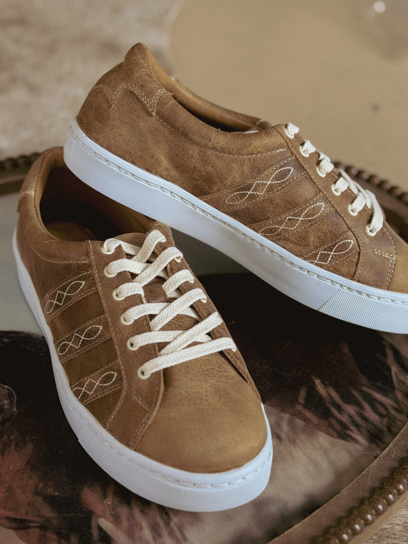 Brown western-inspired sneakers with white laces and embroidered details on side, casual style
