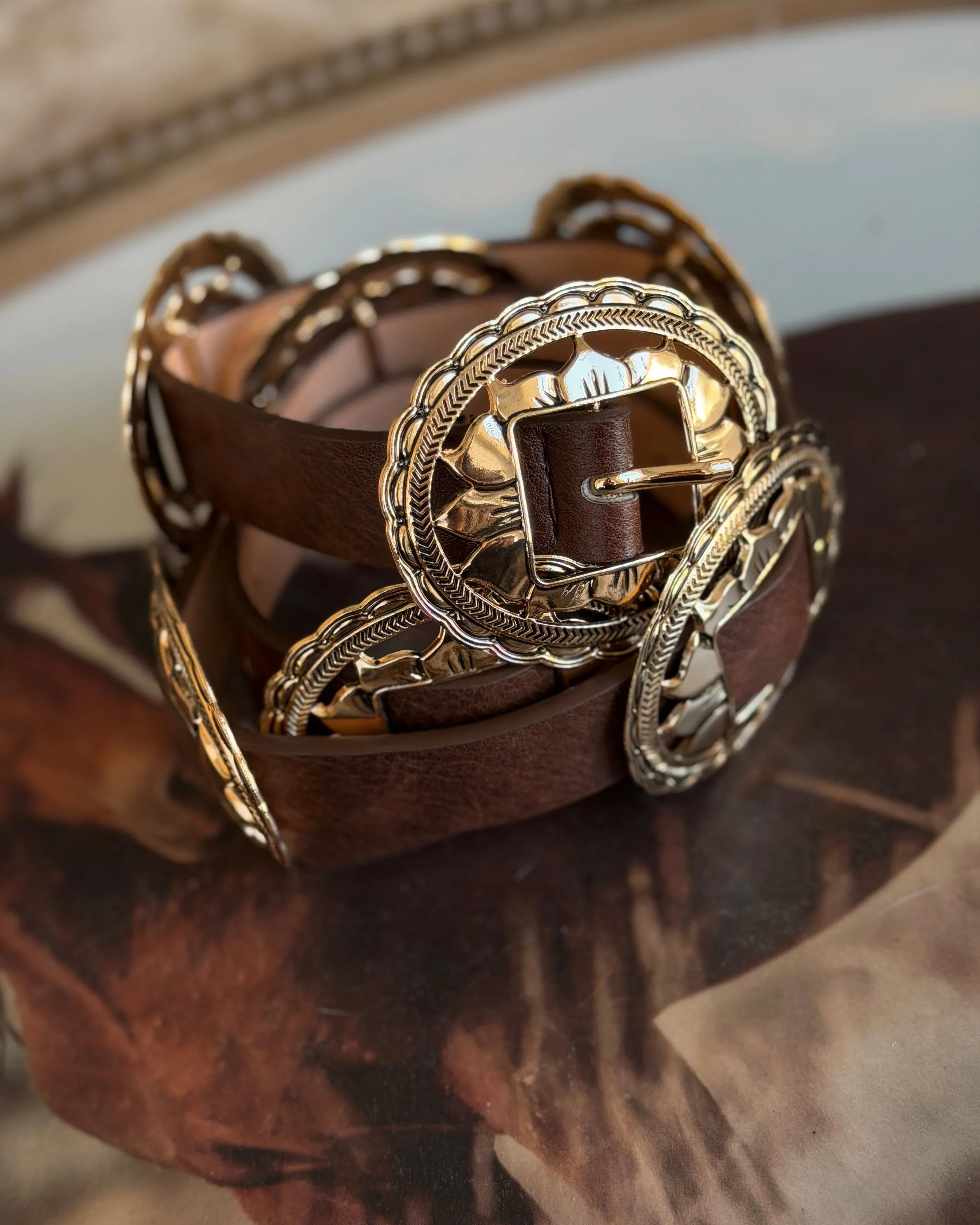 Brown western concho belt with ornate silver buckles, boho cowgirl accessory