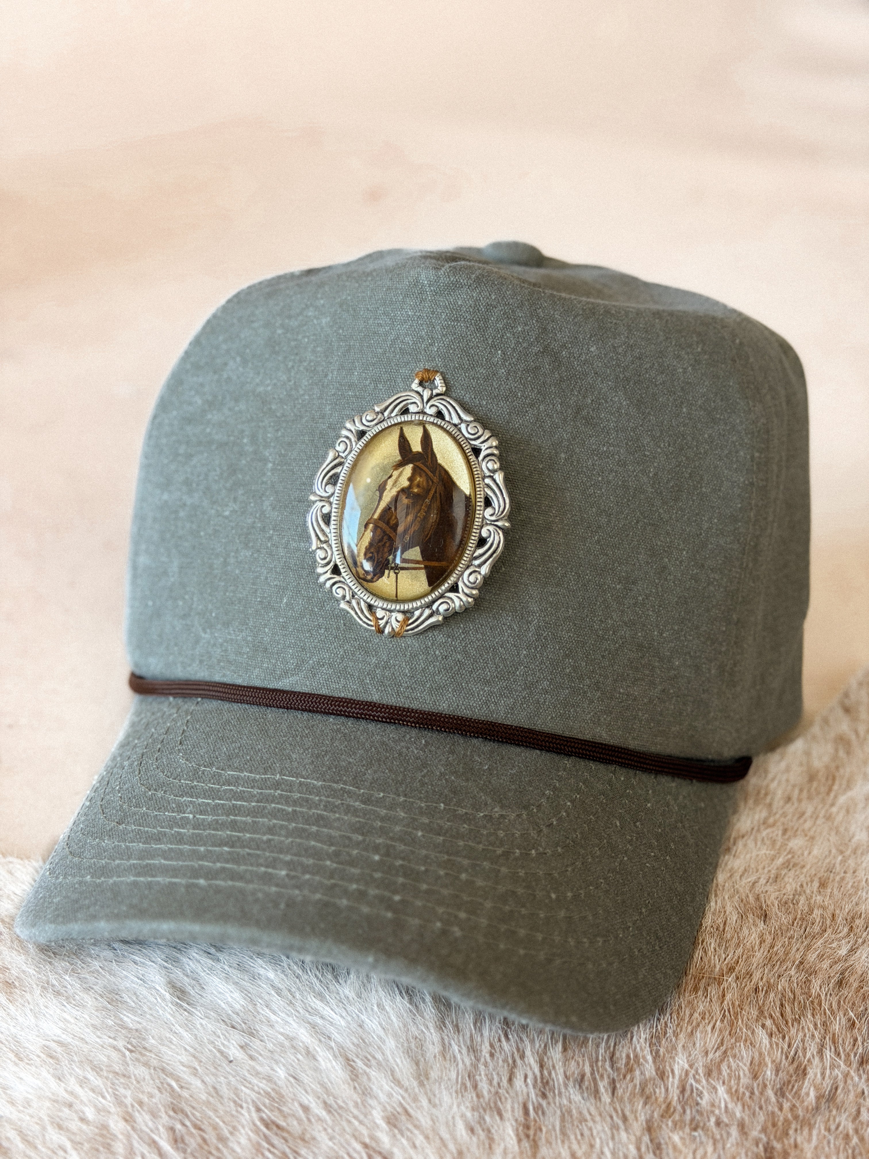 Thunderbird pendant chain necklace displayed on wooden slab with serape fabric underneath - The Wild J