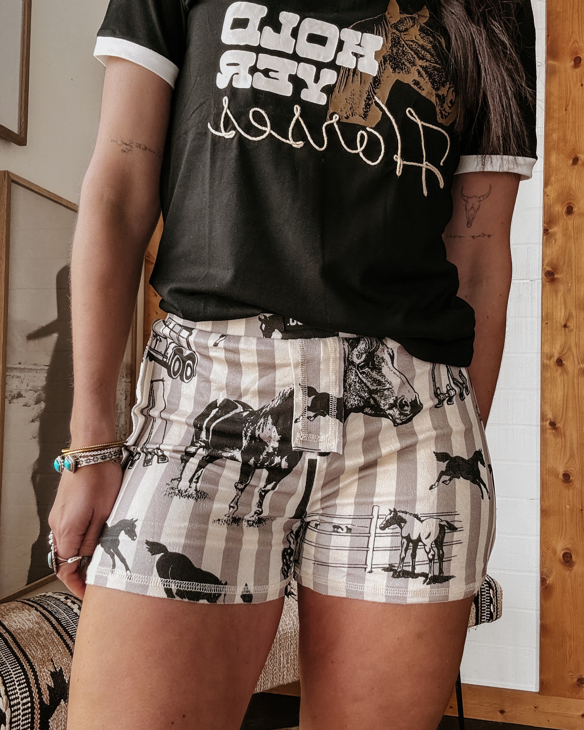 Thunderbird pendant chain necklace displayed on wooden slab with serape fabric underneath - The Wild J