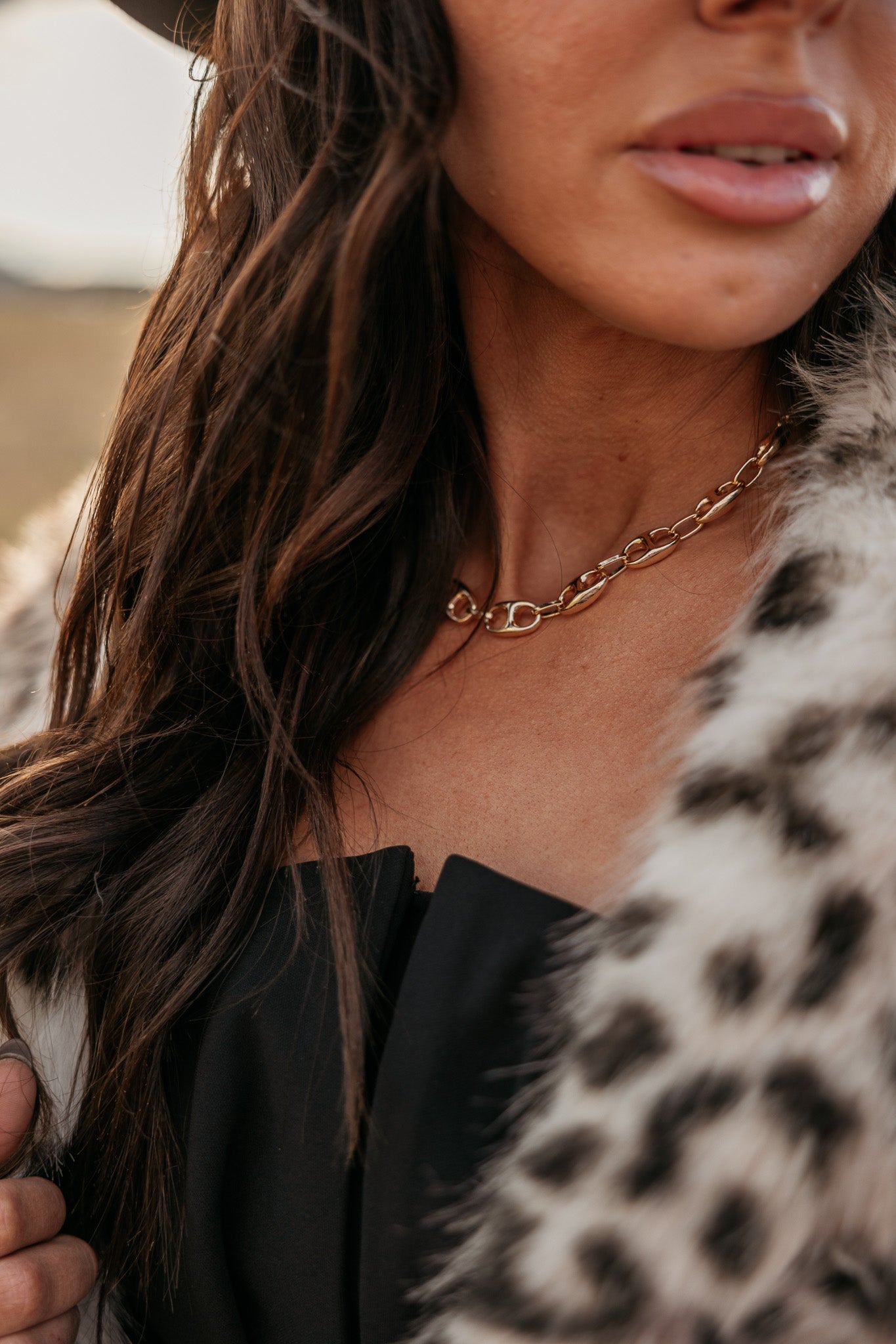 Thunderbird pendant chain necklace displayed on wooden slab with serape fabric underneath - The Wild J