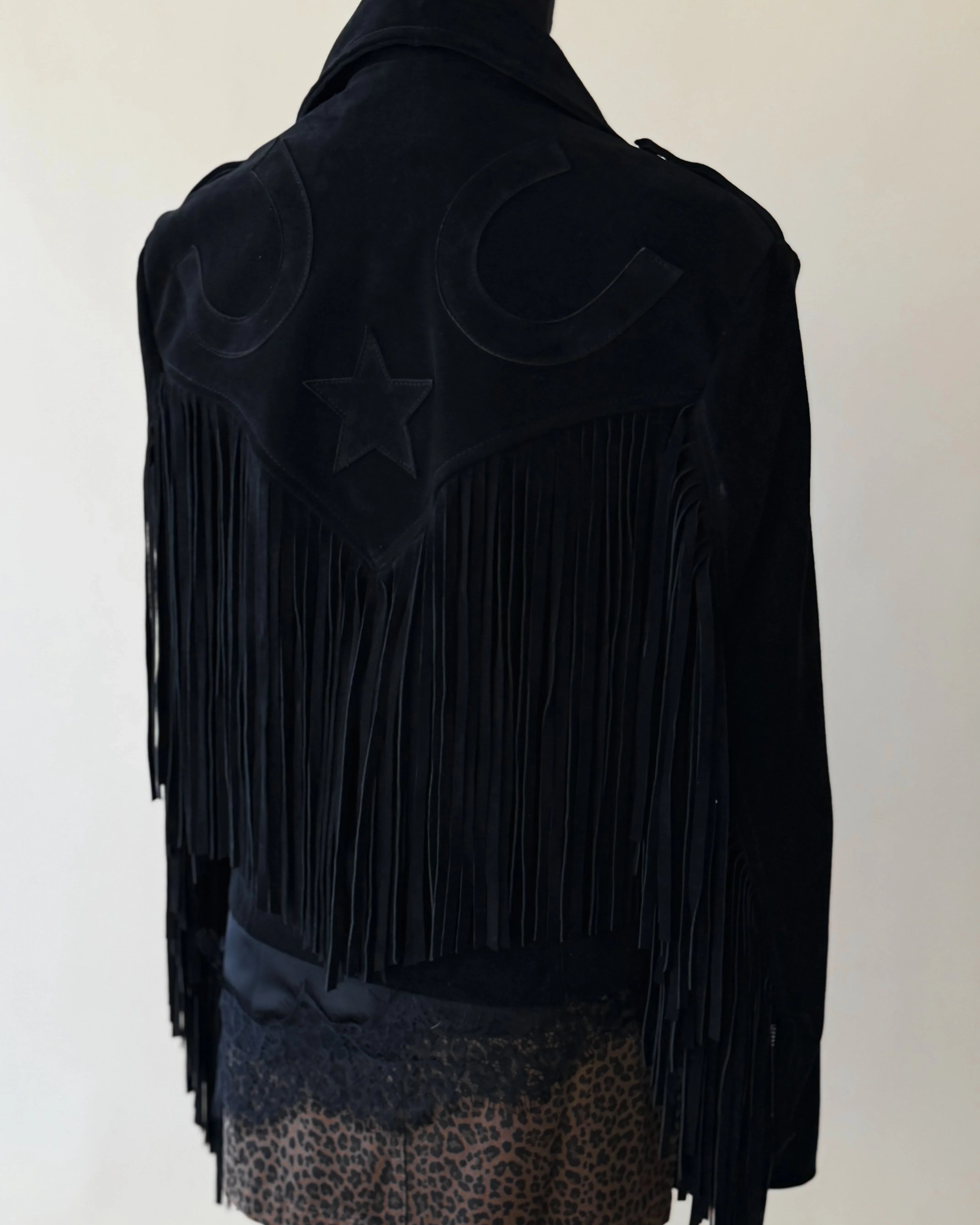 Black western fringe jacket with star and horseshoe details, styled with leopard print skirt