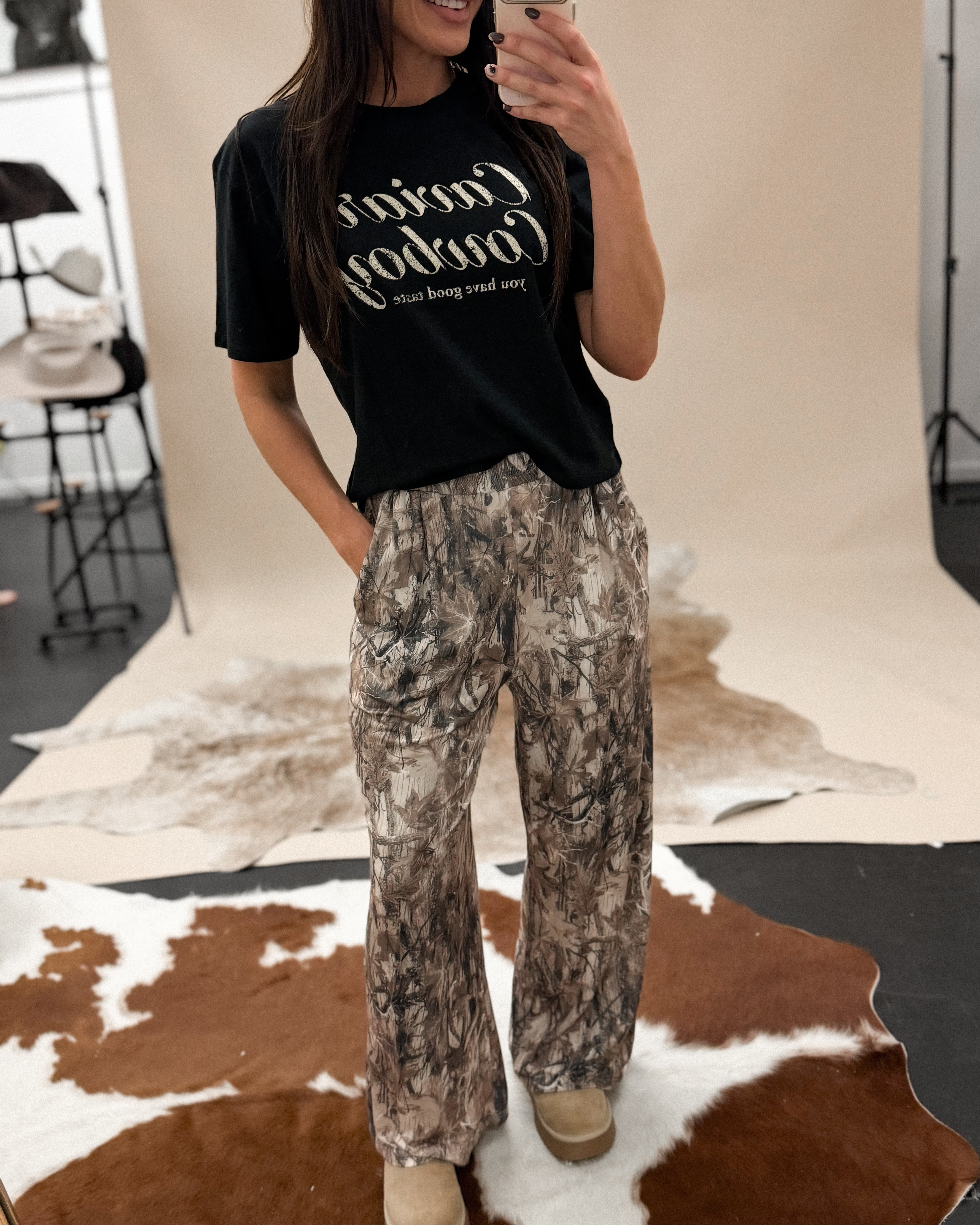 Thunderbird pendant chain necklace displayed on wooden slab with serape fabric underneath - The Wild J