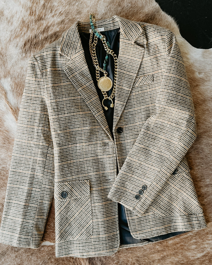 Plaid blazer on a textured surface