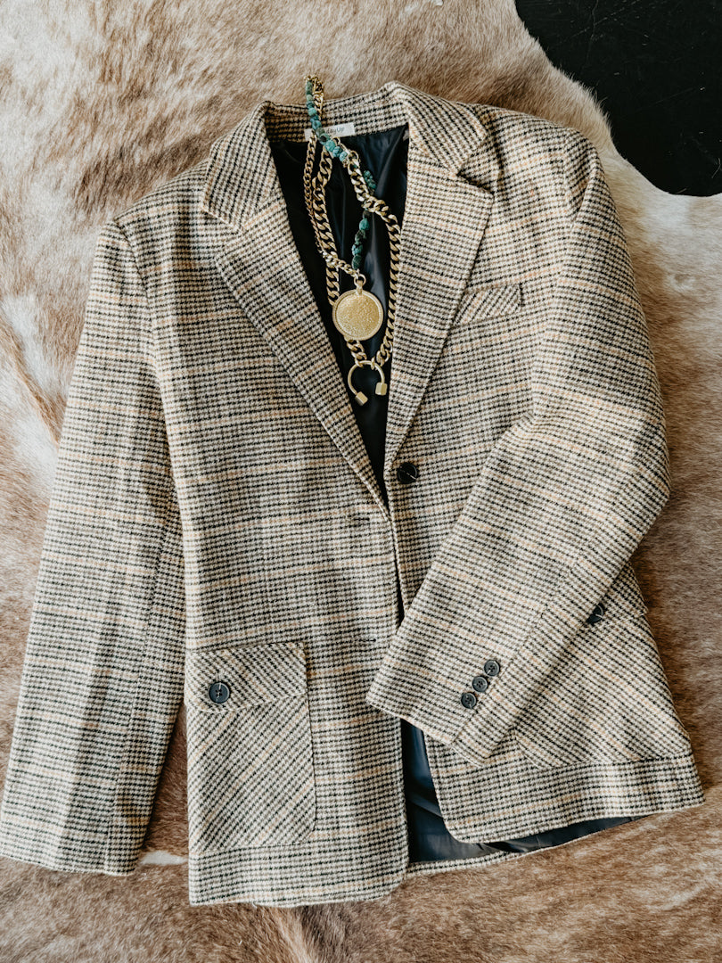 Plaid blazer on a textured surface