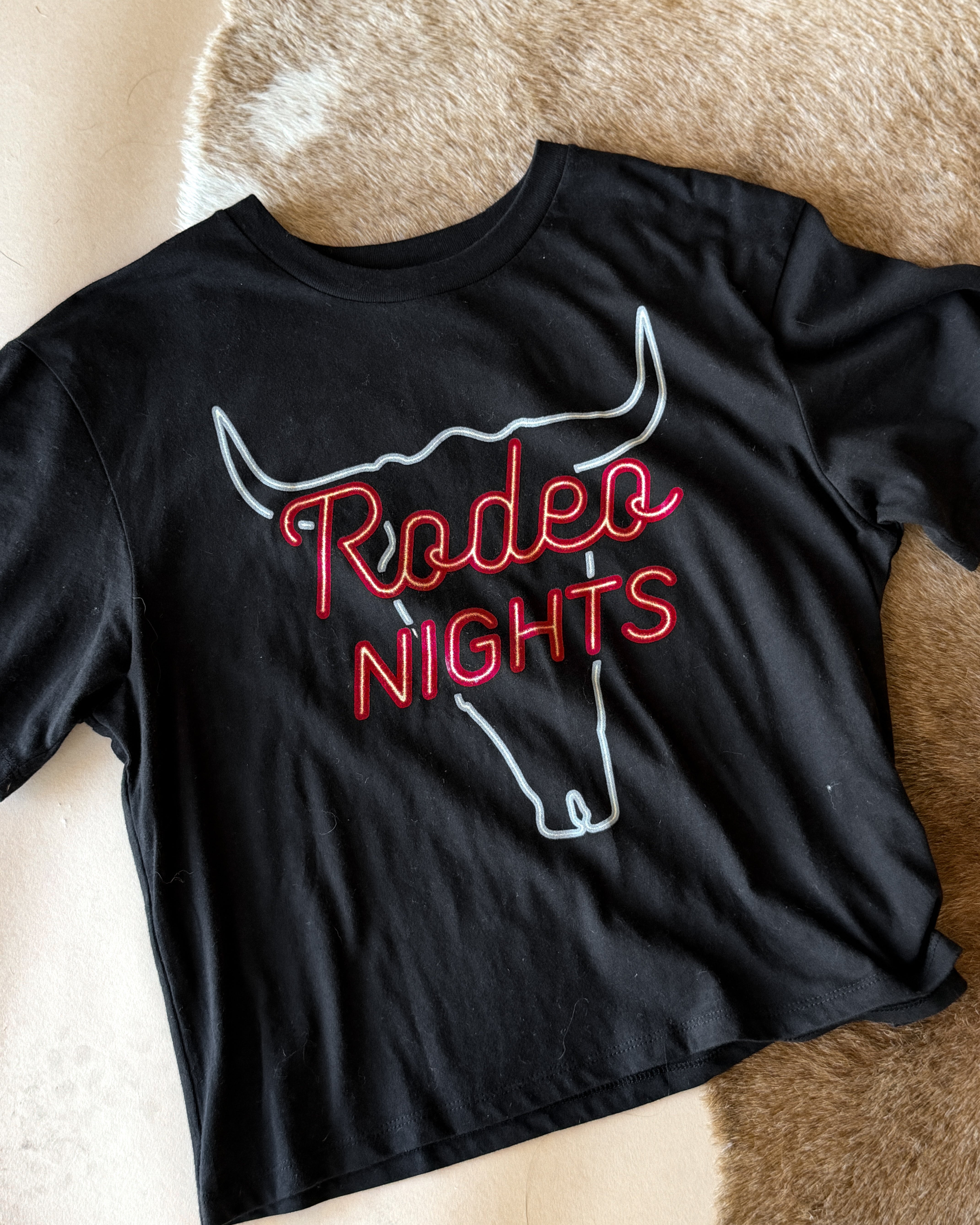 Thunderbird pendant chain necklace displayed on wooden slab with serape fabric underneath - The Wild J