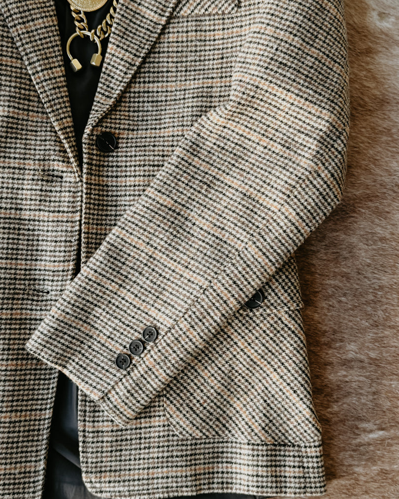Houndstooth patterned coat on a textured surface