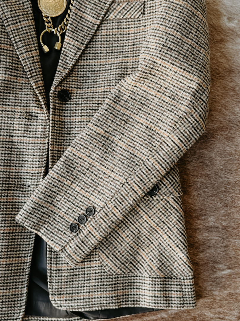 Houndstooth patterned coat on a textured surface