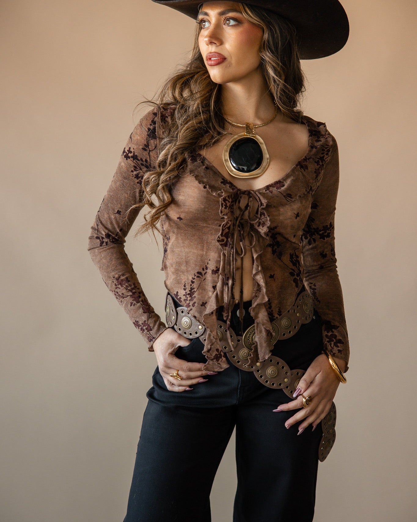 Thunderbird pendant chain necklace displayed on wooden slab with serape fabric underneath - The Wild J