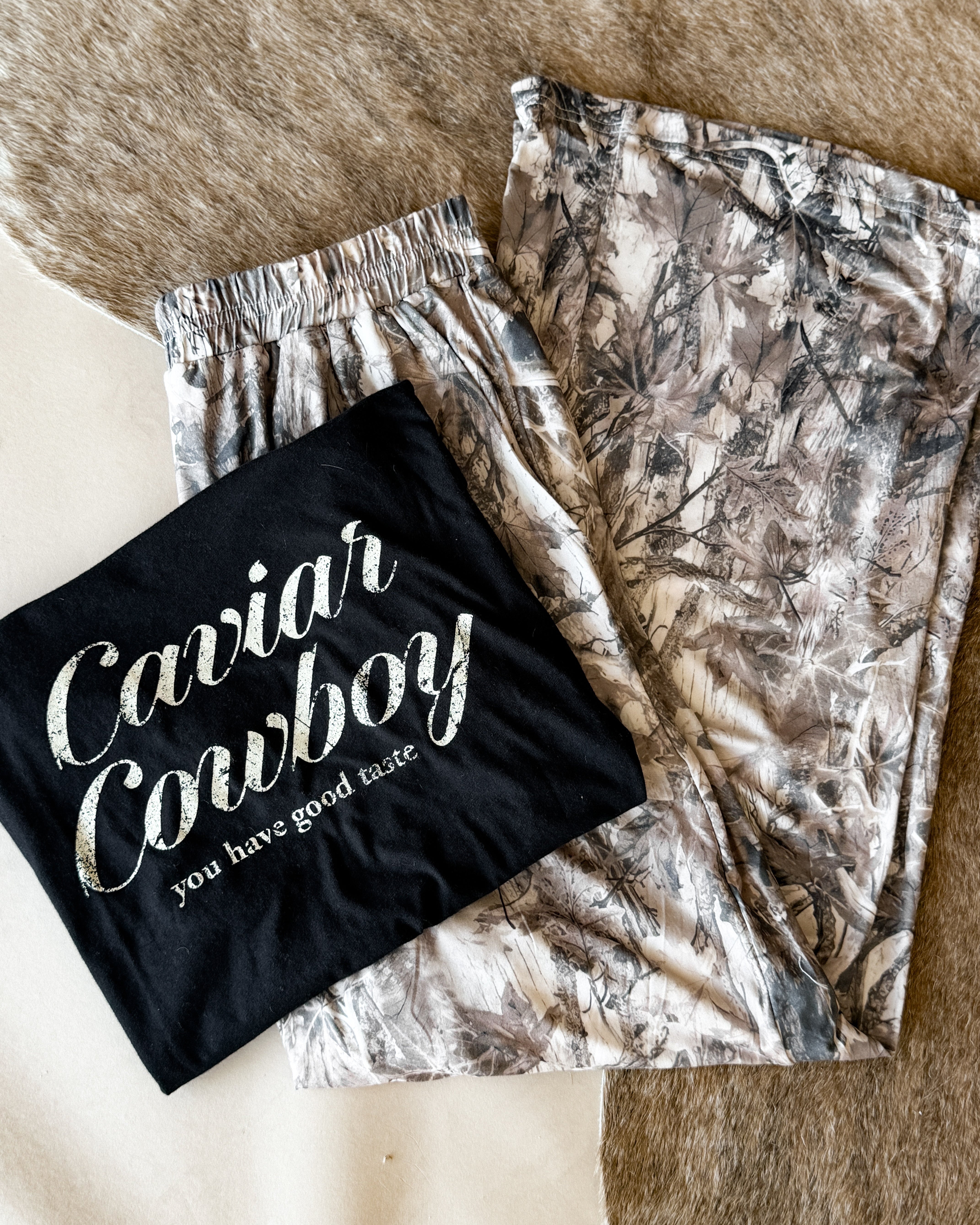 Thunderbird pendant chain necklace displayed on wooden slab with serape fabric underneath - The Wild J