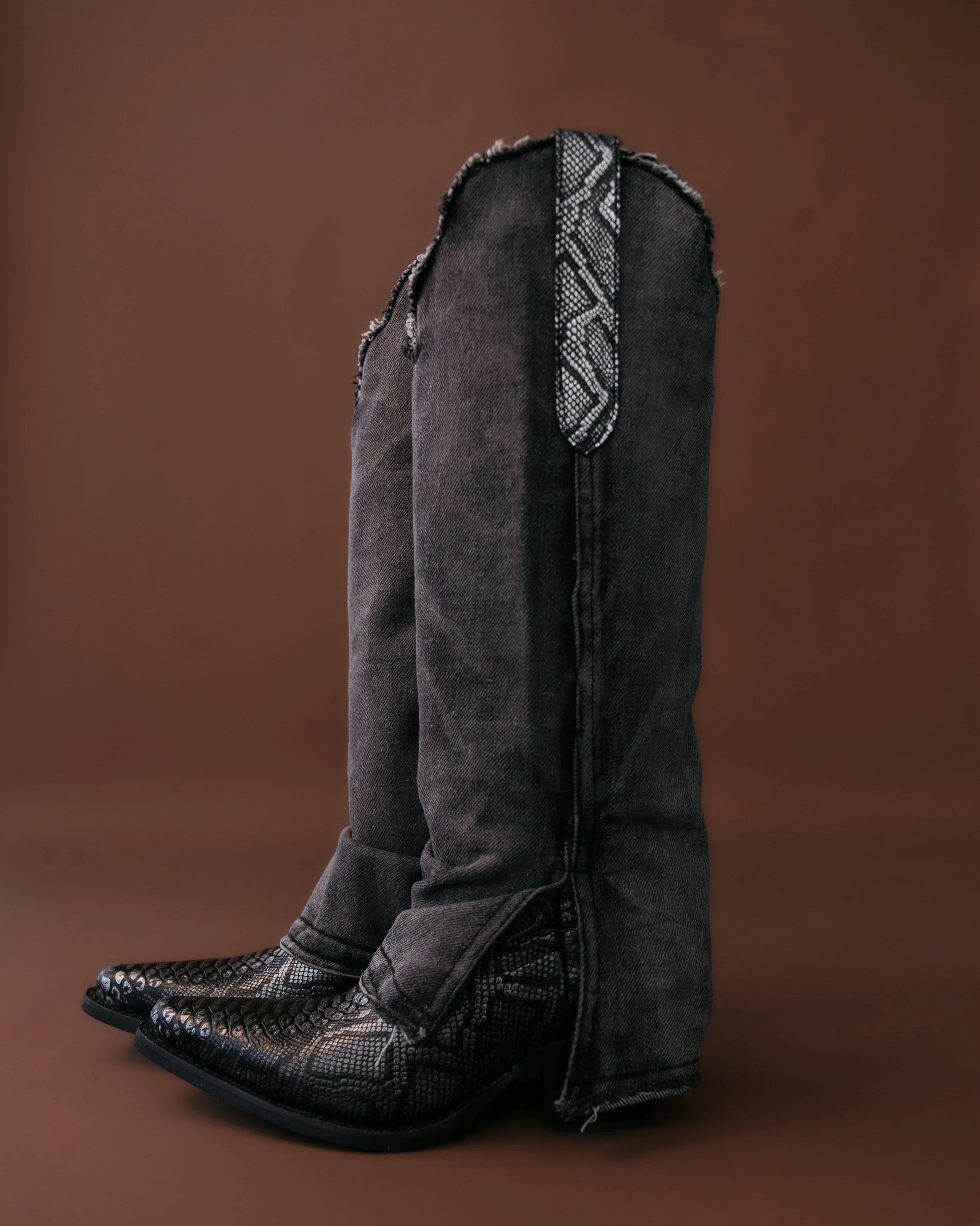 Black western boots with denim flare pants and snakeskin detail, cowgirl boho style