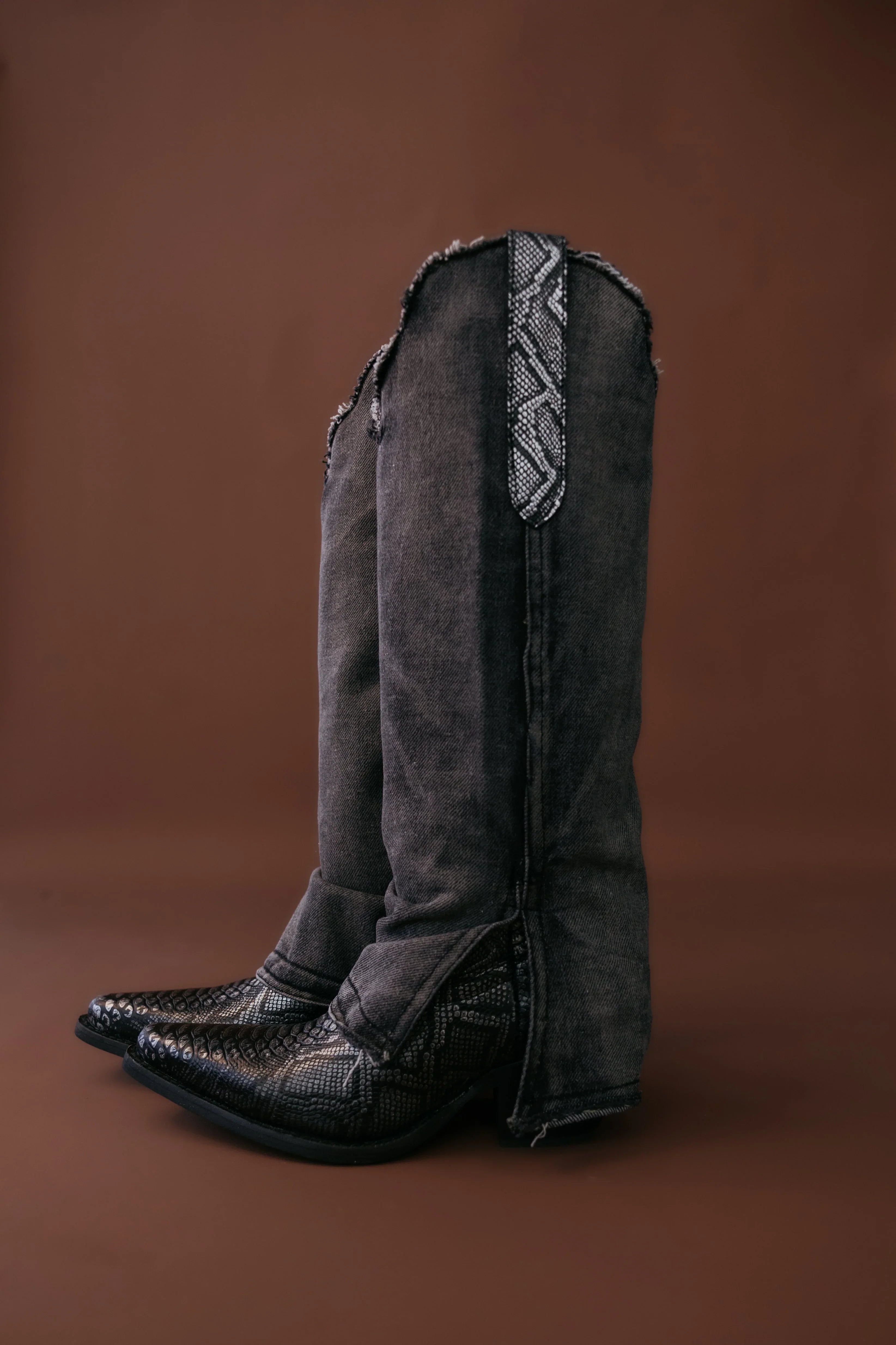 Black western boots with denim flare pants and snakeskin detail, cowgirl boho style