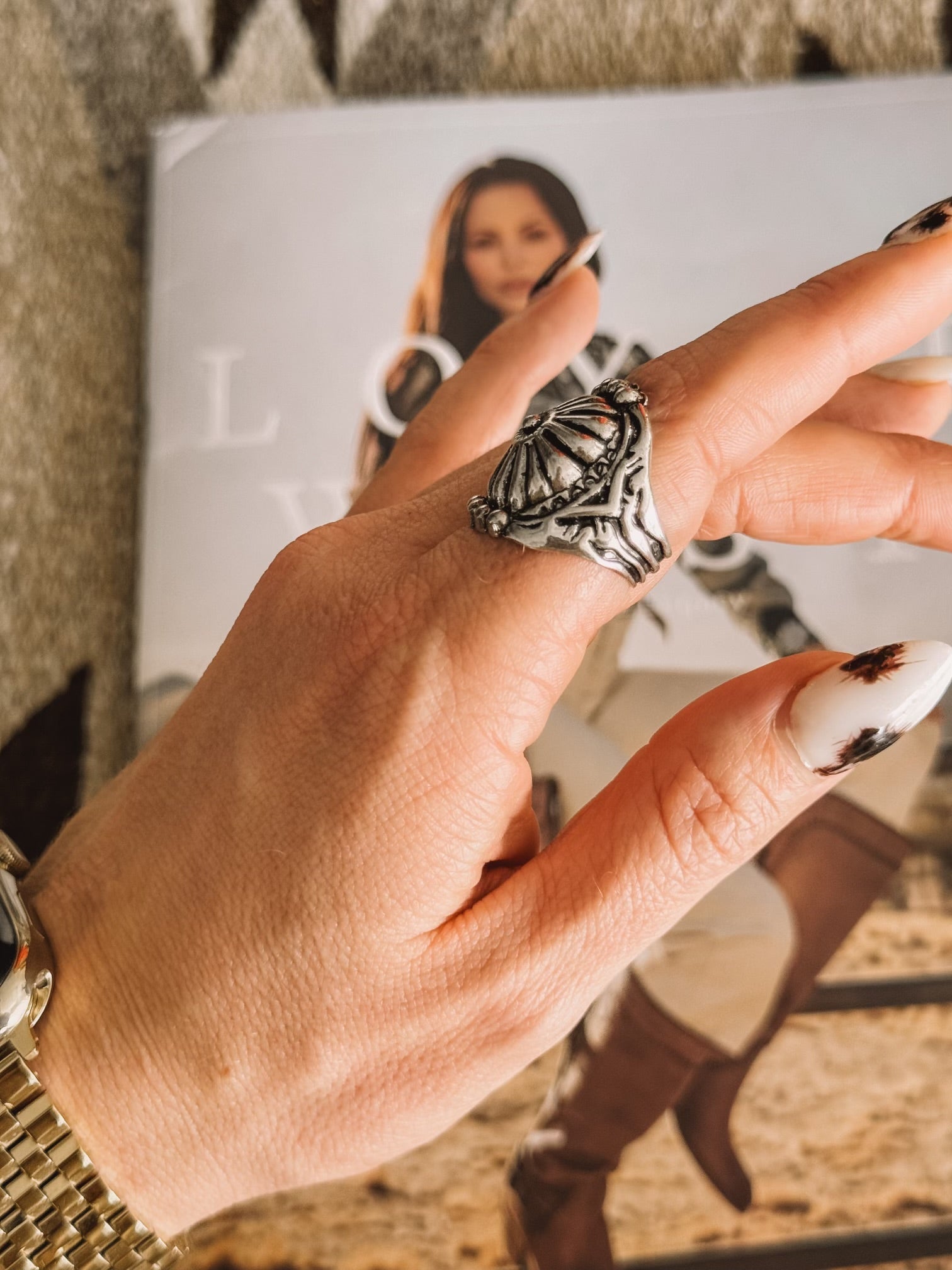 Thunderbird pendant chain necklace displayed on wooden slab with serape fabric underneath - The Wild J