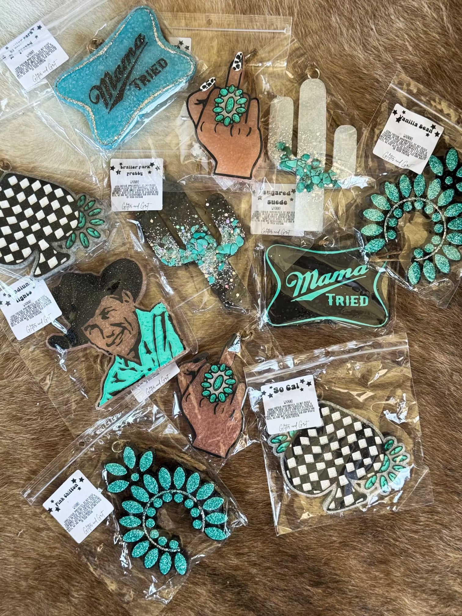 Western boho car freshies with turquoise designs and cowgirl motifs on cowhide background