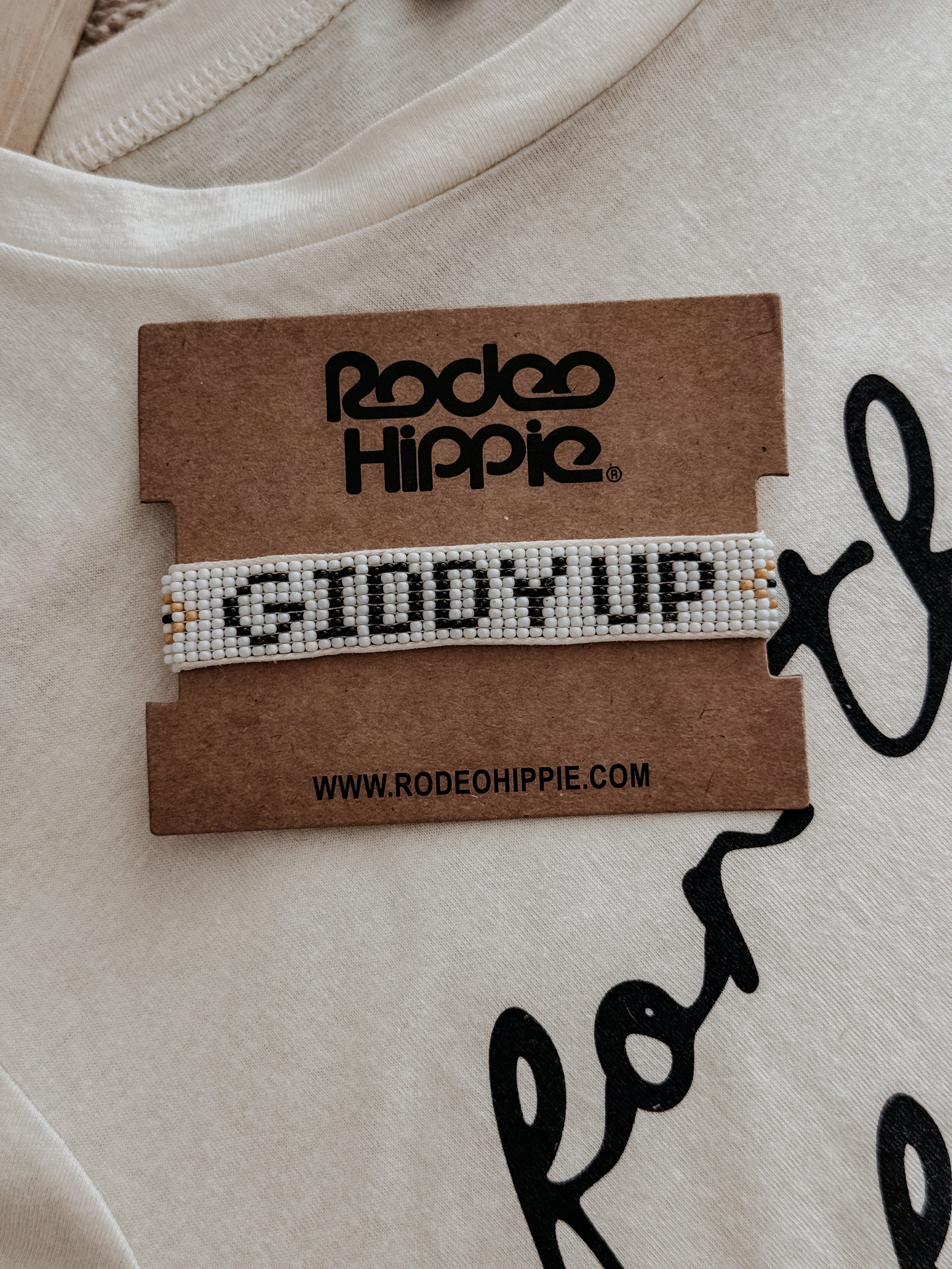 Thunderbird pendant chain necklace displayed on wooden slab with serape fabric underneath - The Wild J