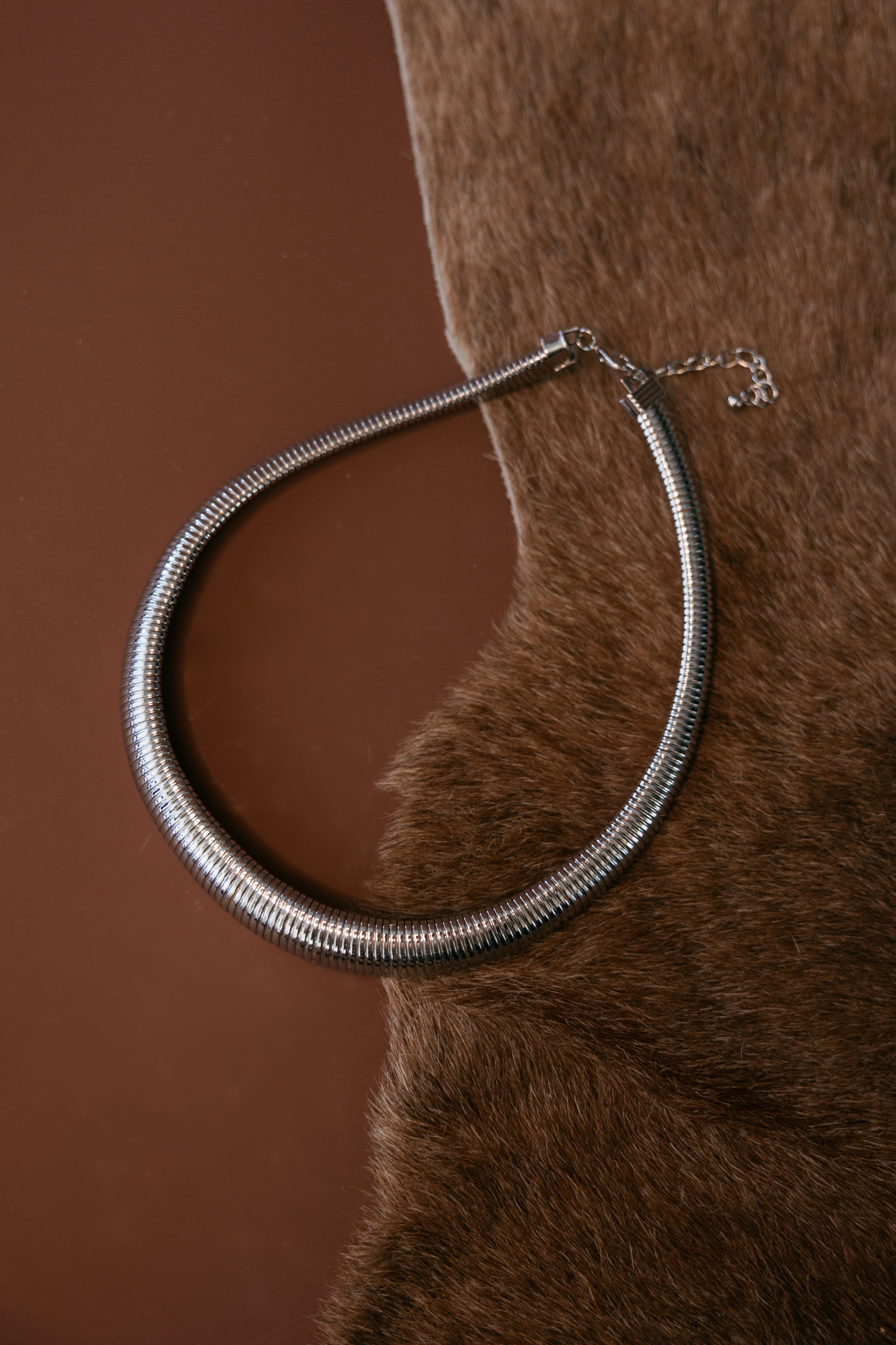 Silver‑plated Omega Cobra mega collar necklace with flexible tubogas spiral construction and lobster‑claw closure.