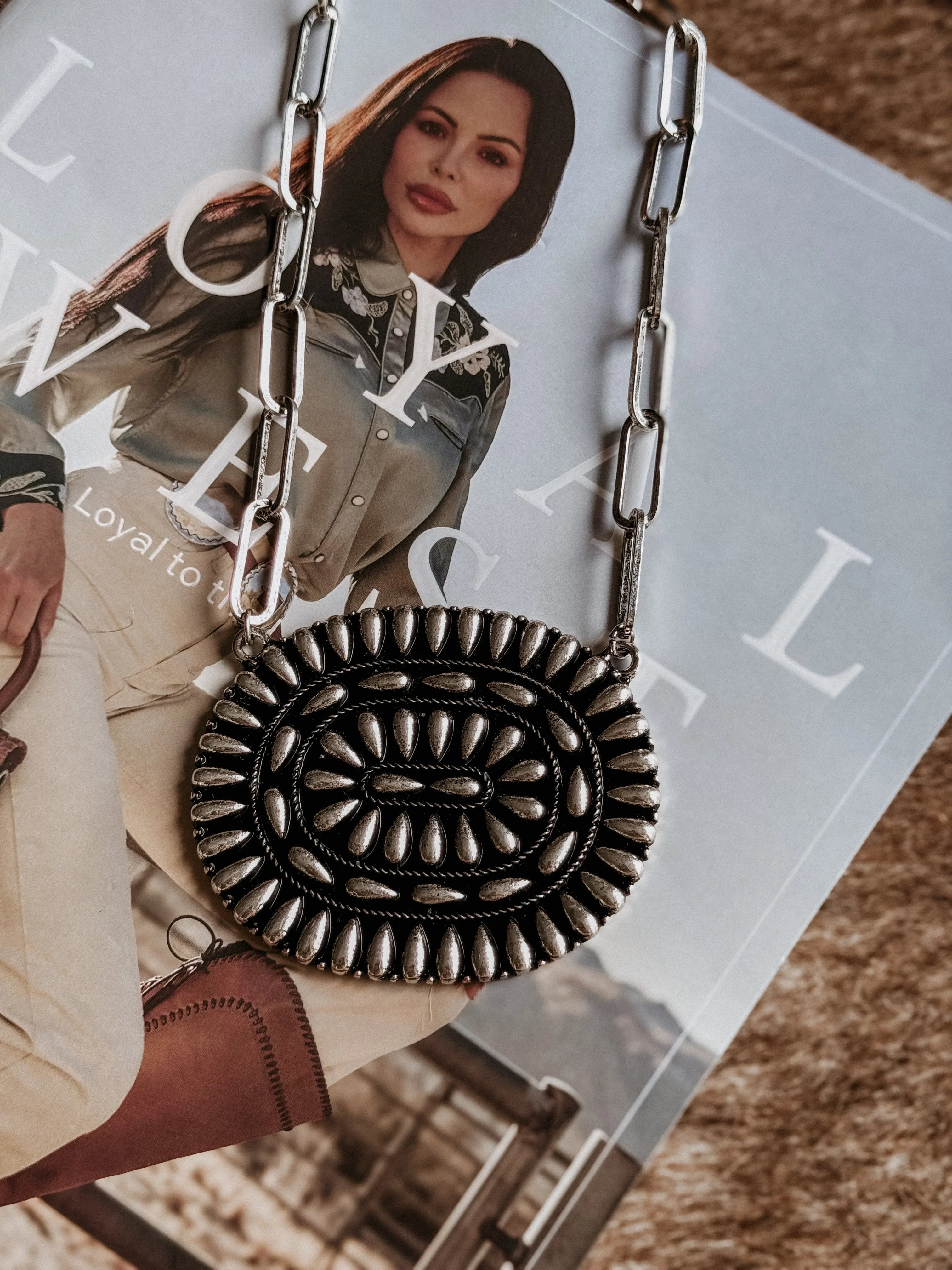 Necklace with intricate bubble design on a magazine background