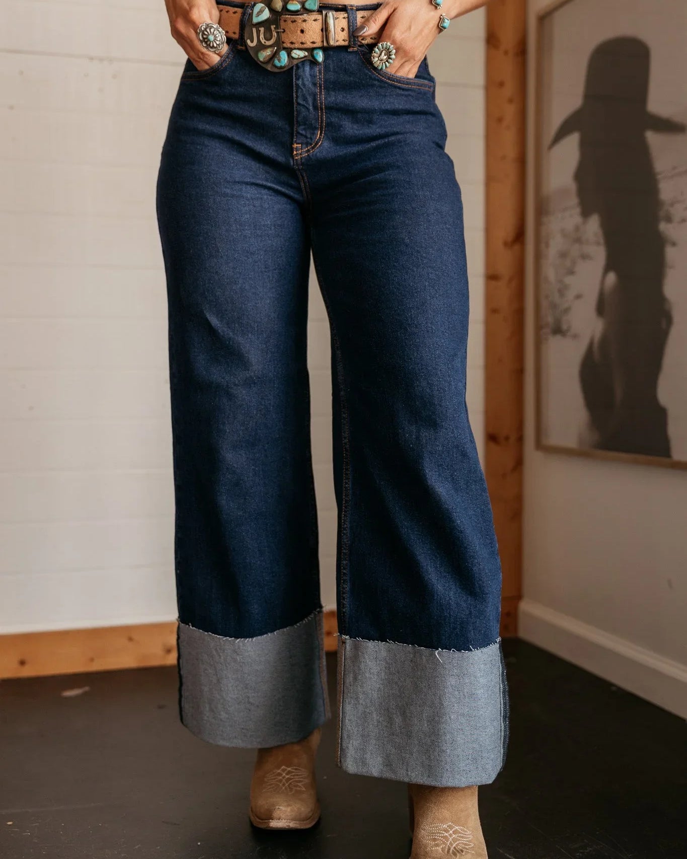 High rise western cuff jeans with wide legs, statement belt, and cowgirl boots