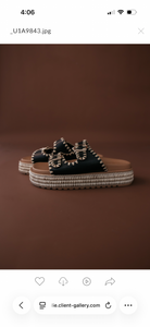 Thunderbird pendant chain necklace displayed on wooden slab with serape fabric underneath - The Wild J