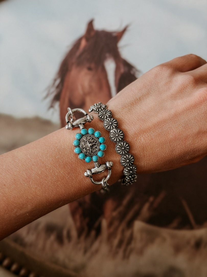 Thunderbird pendant chain necklace displayed on wooden slab with serape fabric underneath - The Wild J